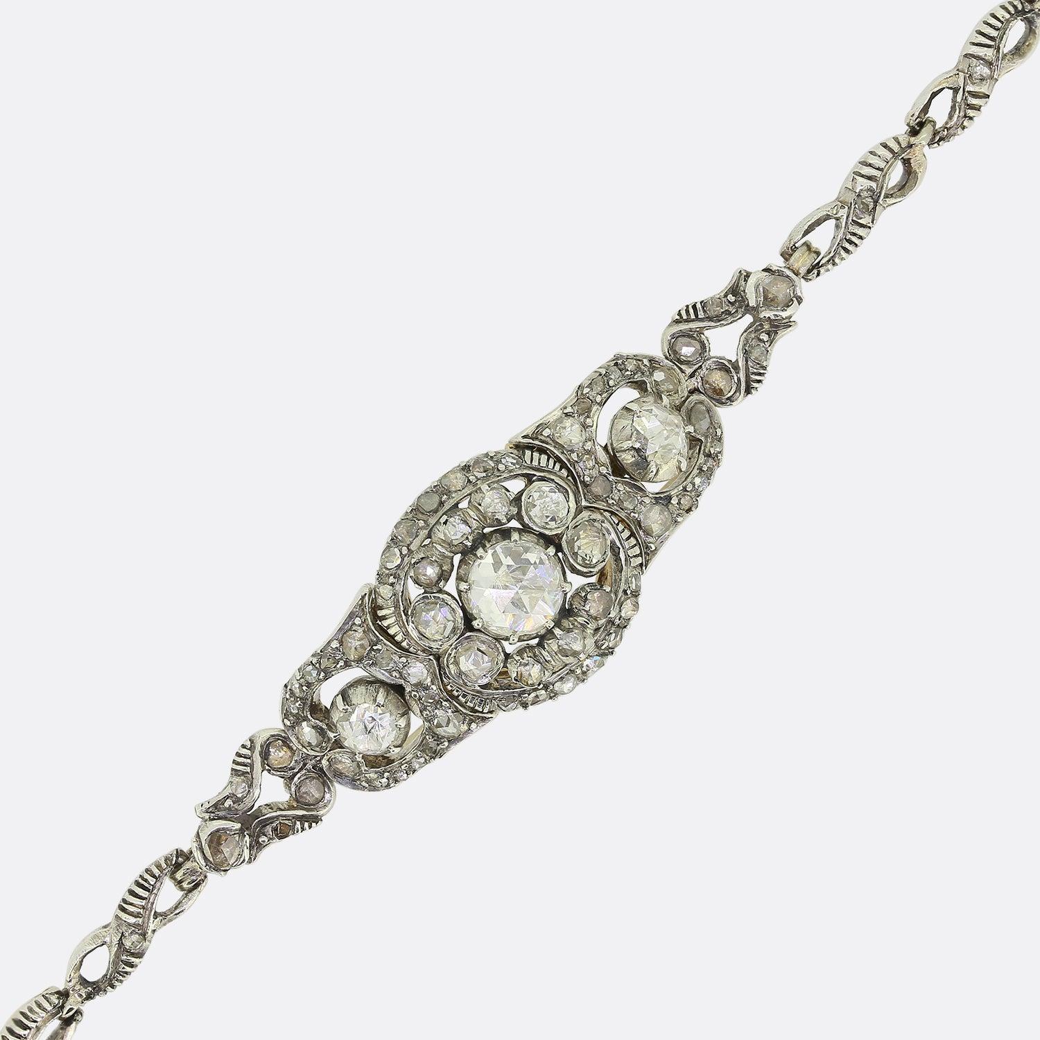 This is a truly wonderful 14ct yellow gold bracelet from the Victorian era. The focal point of the bracelet is a large rose cut centre stone which is surrounded by an array of further rose cut diamonds. The bracelet is of continental origin and