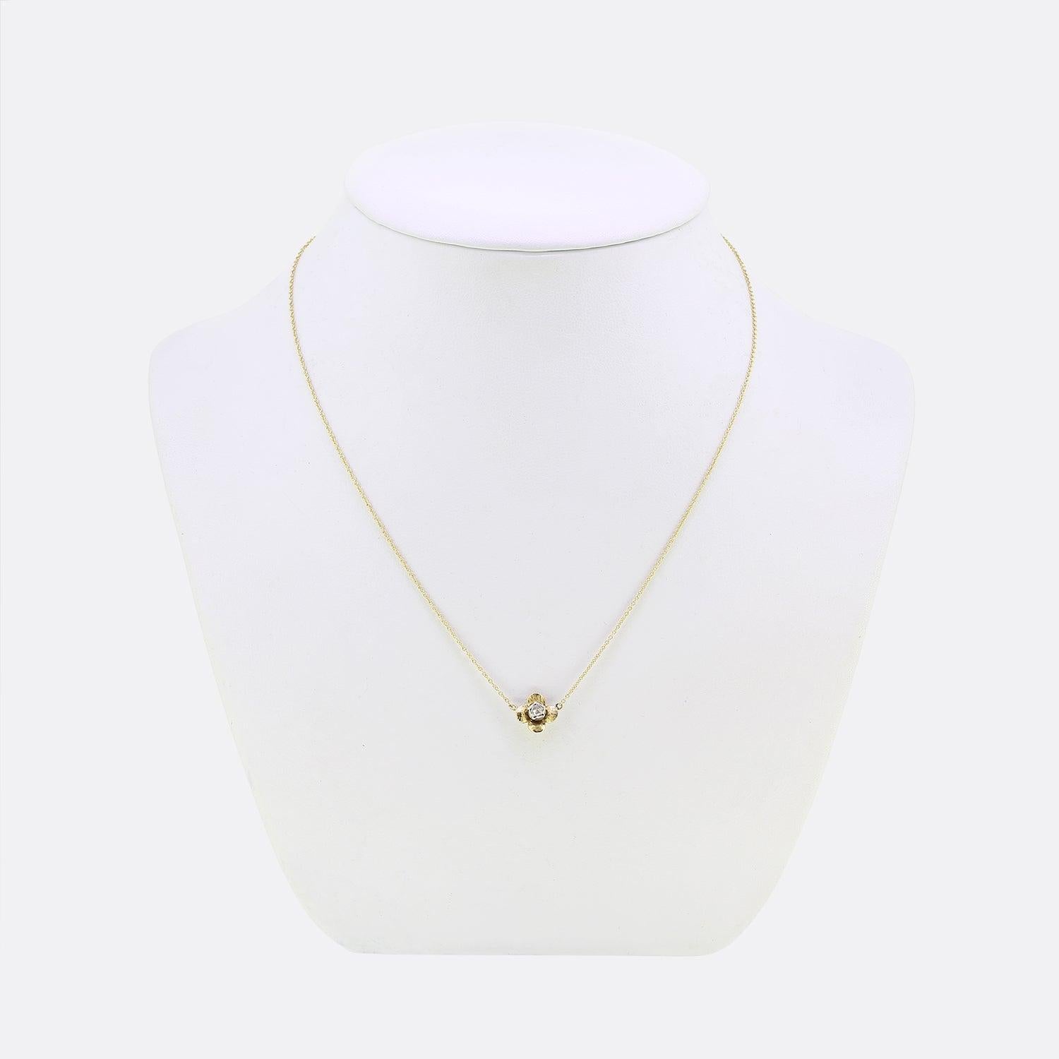 This is a lovely Victorian diamond necklace. Crafted to form the shape of flower head, this 15ct yellow gold pendant focally showcases a cut collet set round rose cut diamond at the centre acting as the pistil of the flower. The piece is finished by