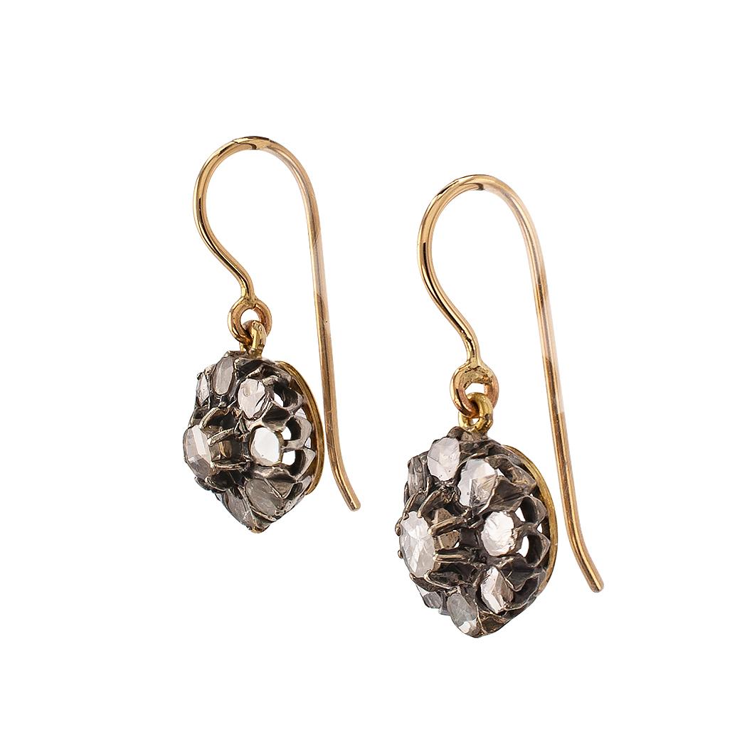 Victorian rose cut diamond gold and silver drop earrings circa 1890. The circular designs set throughout with rose cut diamonds totaling approximately 0.70 carat, mounted in silver and 14-karat yellow gold. Very pristine condition consistent with