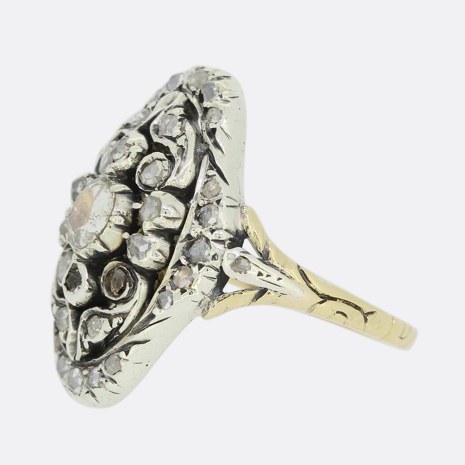 This is a Victorian rose cut diamond navette ring. The ring is set with multiple rose cut diamonds in a navette shaped setting crafted in silver with a 15ct yellow gold decorative band.

Condition: Used (Very Good)
Weight: 4.8 grams
Ring Size: M