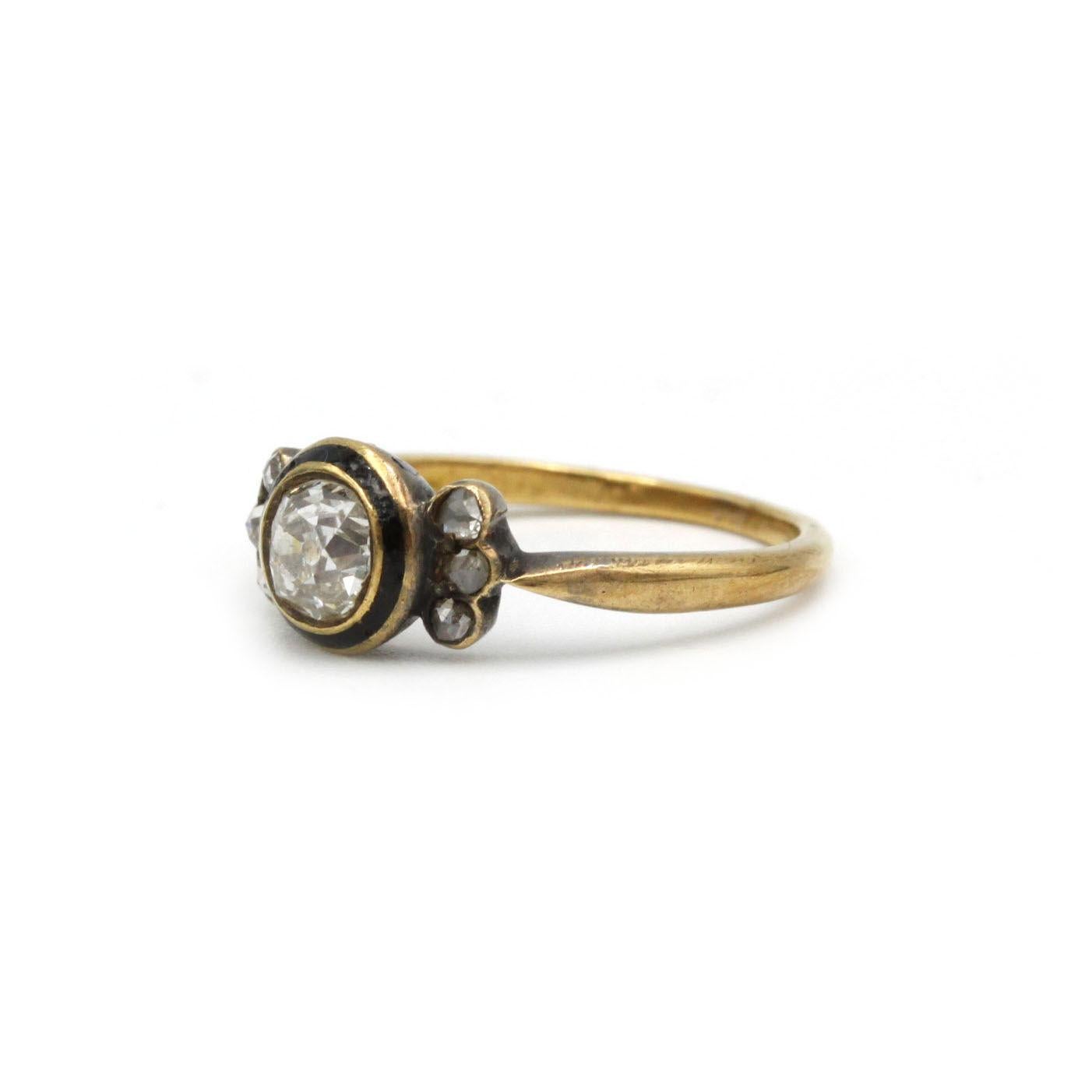 Crafted in 18-carat yellow gold, this exquisite ring centers on a single rose-cut diamond of approximately 0.50 carat, bezel-set in a gently domed chaton. Flanking the central gem are six smaller rose-cut diamonds, each delicately clustered in
