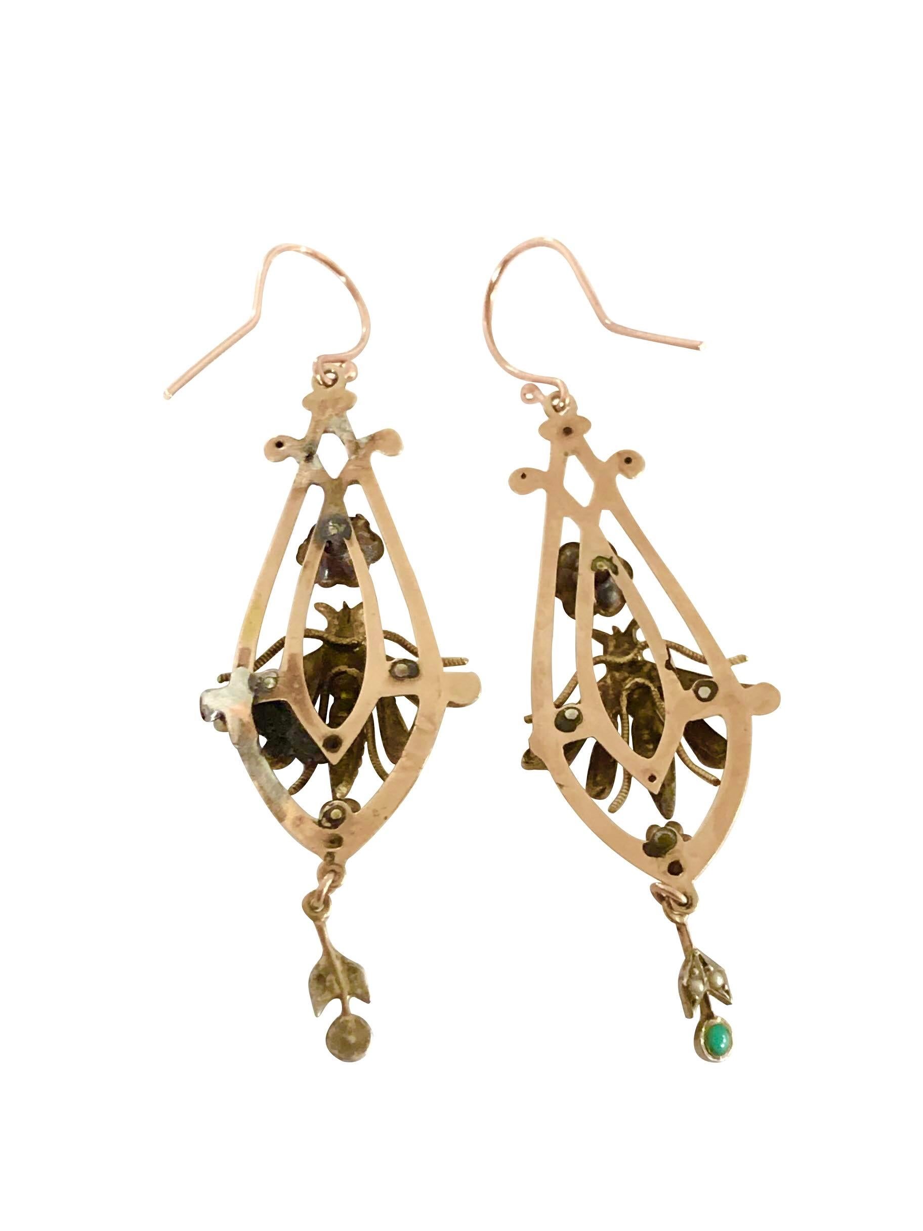 Circa 1880s Victorian Rose Gold Earrings, measuring 2 1/4 inches in length and 3/4 inch wide. having a silver winged Bug in the center with Ruby Eyes and Seed Pearls and Turquoise set throughout. 