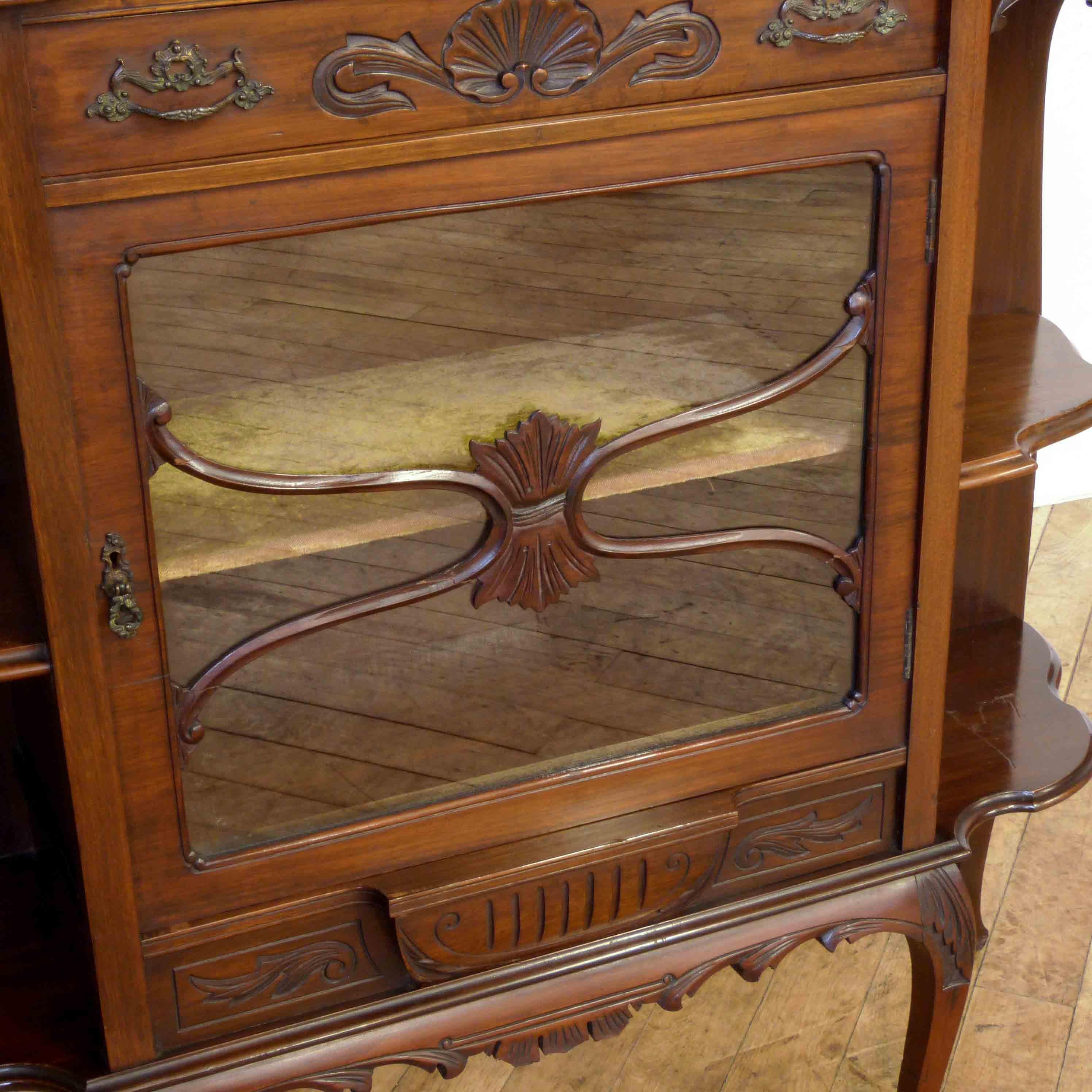 An attractive rosewood chiffonier with a typical arrangement of two cupboards below a long central drawer. With well carved flower mouldings and shields to the doors this chiffonier is a nice decorative piece without being too overstated. The back