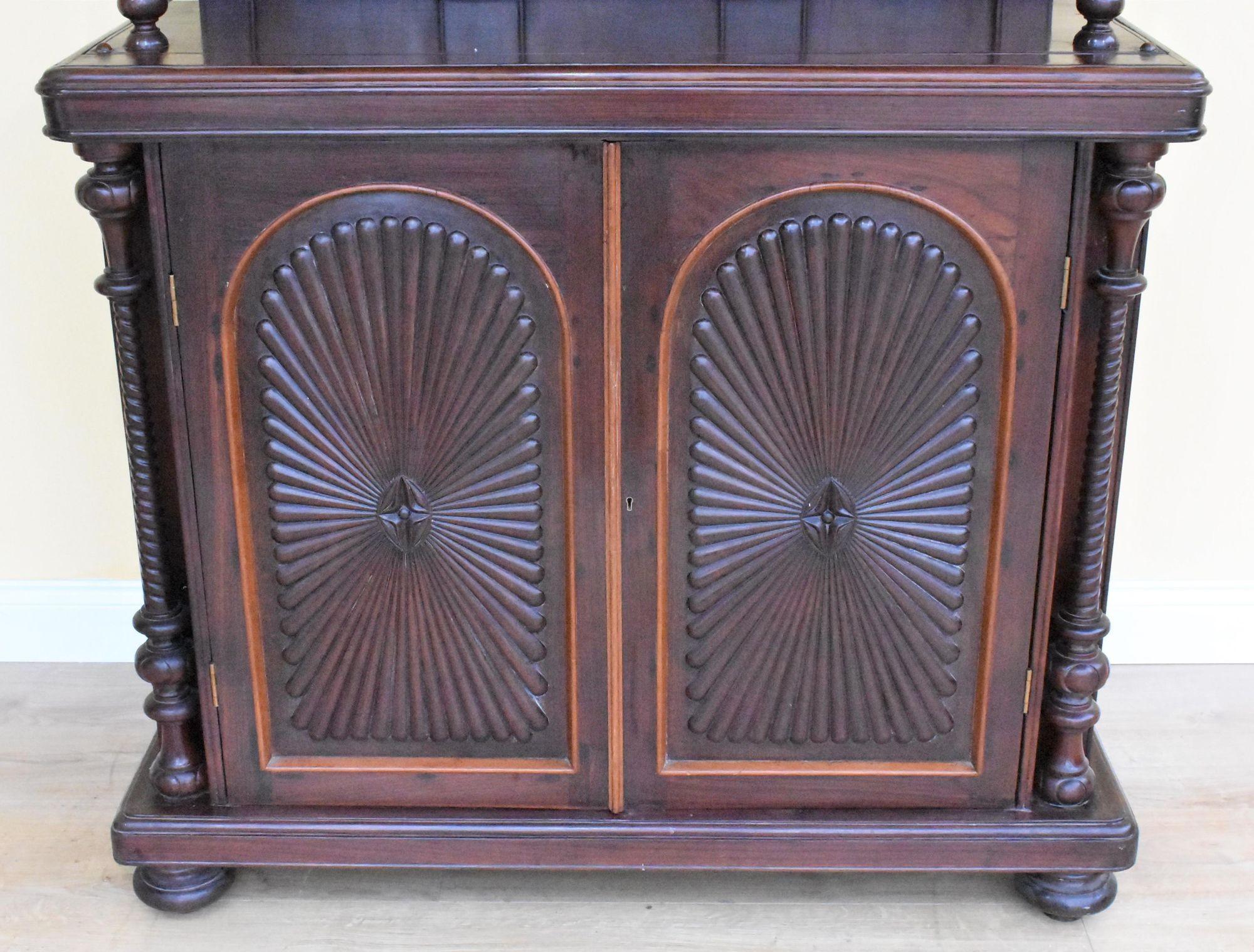 Victorian Rosewood Dresser/cupboard with nice fretwork to the top supported by turned colums with shelf, below decorative cupboard doors enclosing a single removable shelve standing on bun feet. Ring marks to the top and small piece missing to the