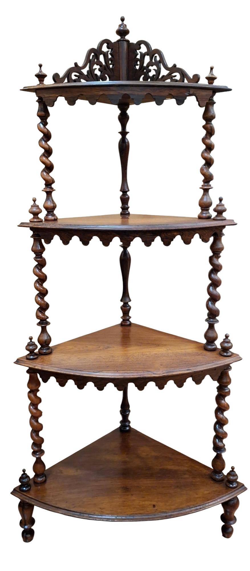 Victorian rosewood 4-tier what-not shelf with well grained shelves, lipped over shaped aprons, each raised on well executed, barley twist risers capped with turned finials. The uppermost shelf features fretwork gallery back.
Raised on turned legs