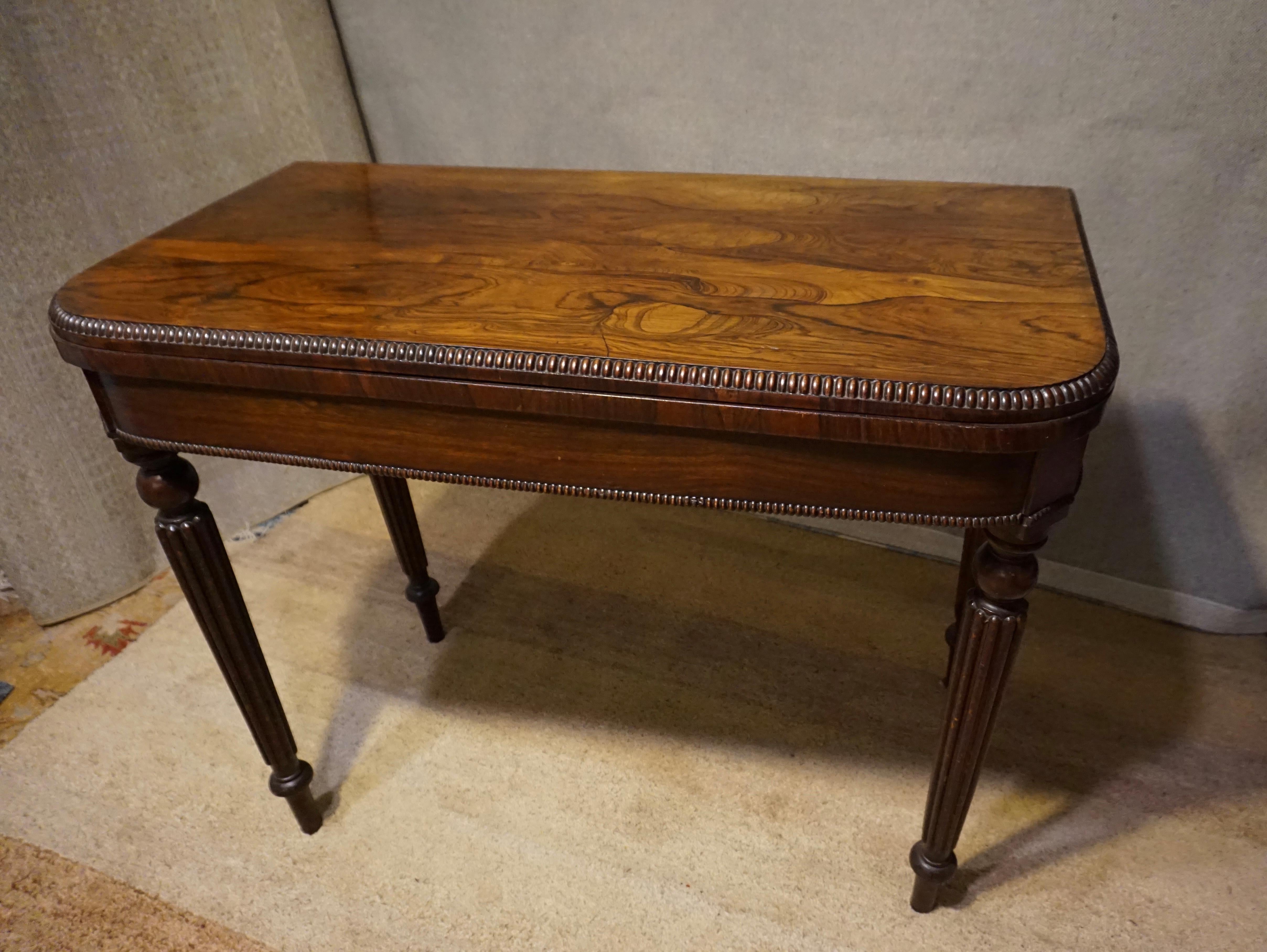Victorian rosewood games table. High end construction and handsome proportions with carved legs and a beaded edge. Original felt top. Excellent grain and patina.

circa 1870s.