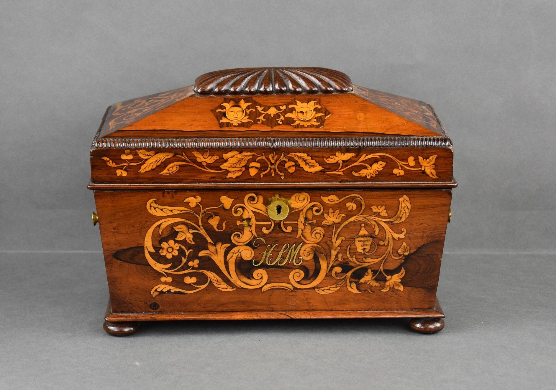 For sale is this 19th Century Victorian antique rosewood inlaid marquetry tea caddy sarcophagus-form box, in good condition with marquetry to the top and front with brass star carrying handles with hinged lid, the interior fitted with two oval