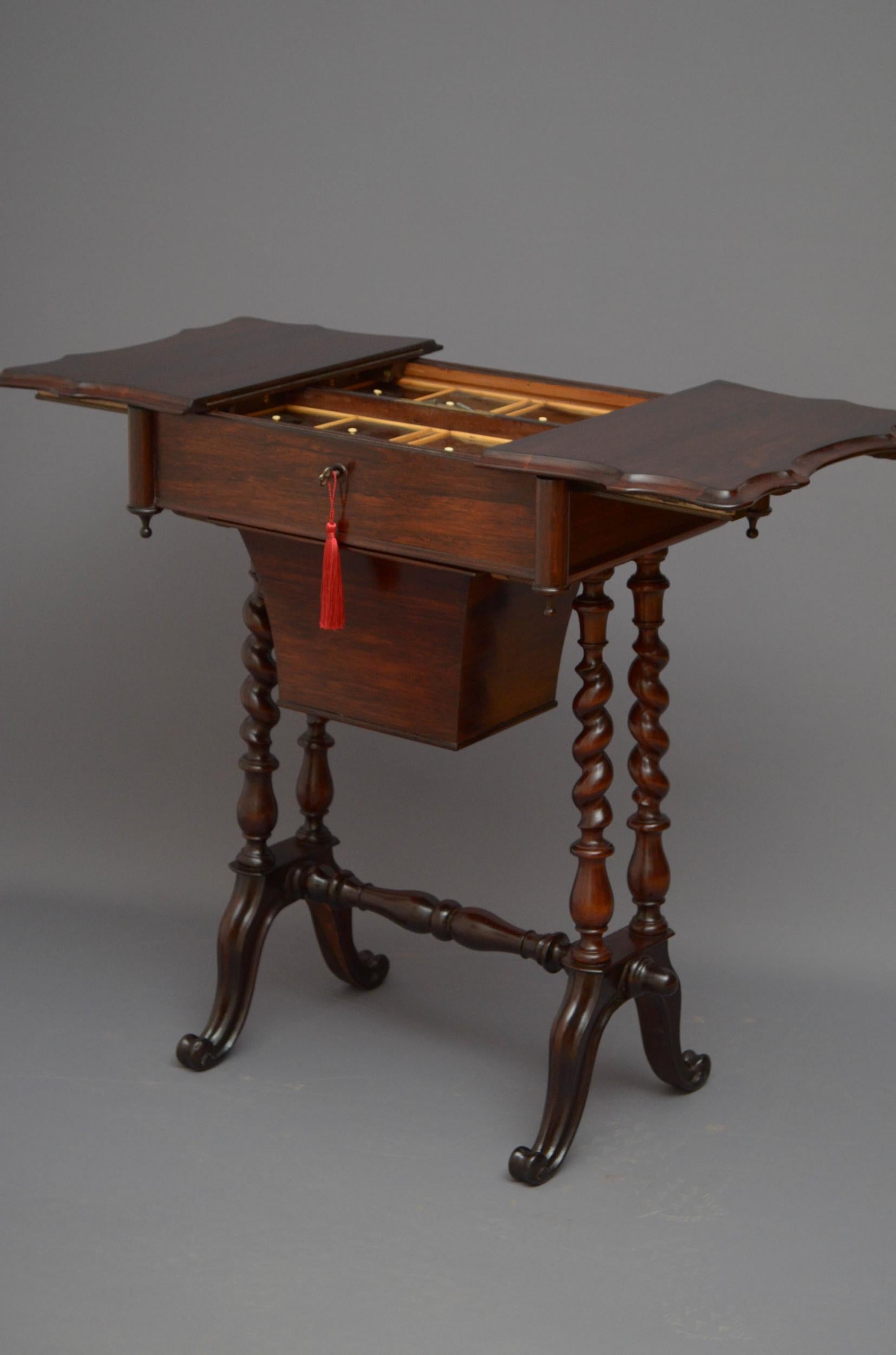 M02, unusual Victorian sewing table in rosewood, having serpentine top fitted with original working lock and a key which open to reveal satinwood compartments with rosewood lids above storage basket, standing on four twisted supports terminating in