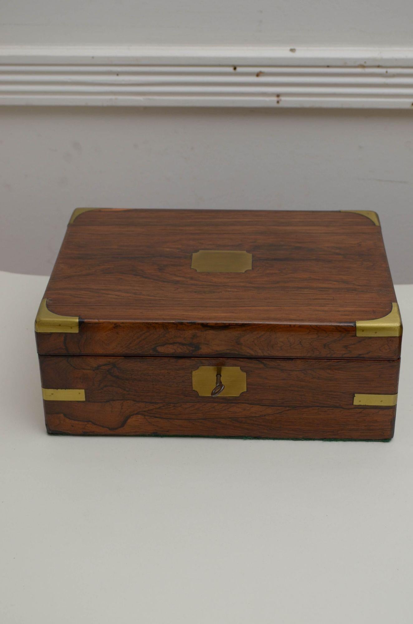 J033 Attractive Victorian rosewood writing box, having brass bounds to each corner and a lift up lid with original working lock and a key which open to reveal pen try, ink well and maroon leather writing surface. All in home ready condition. 1870
H4