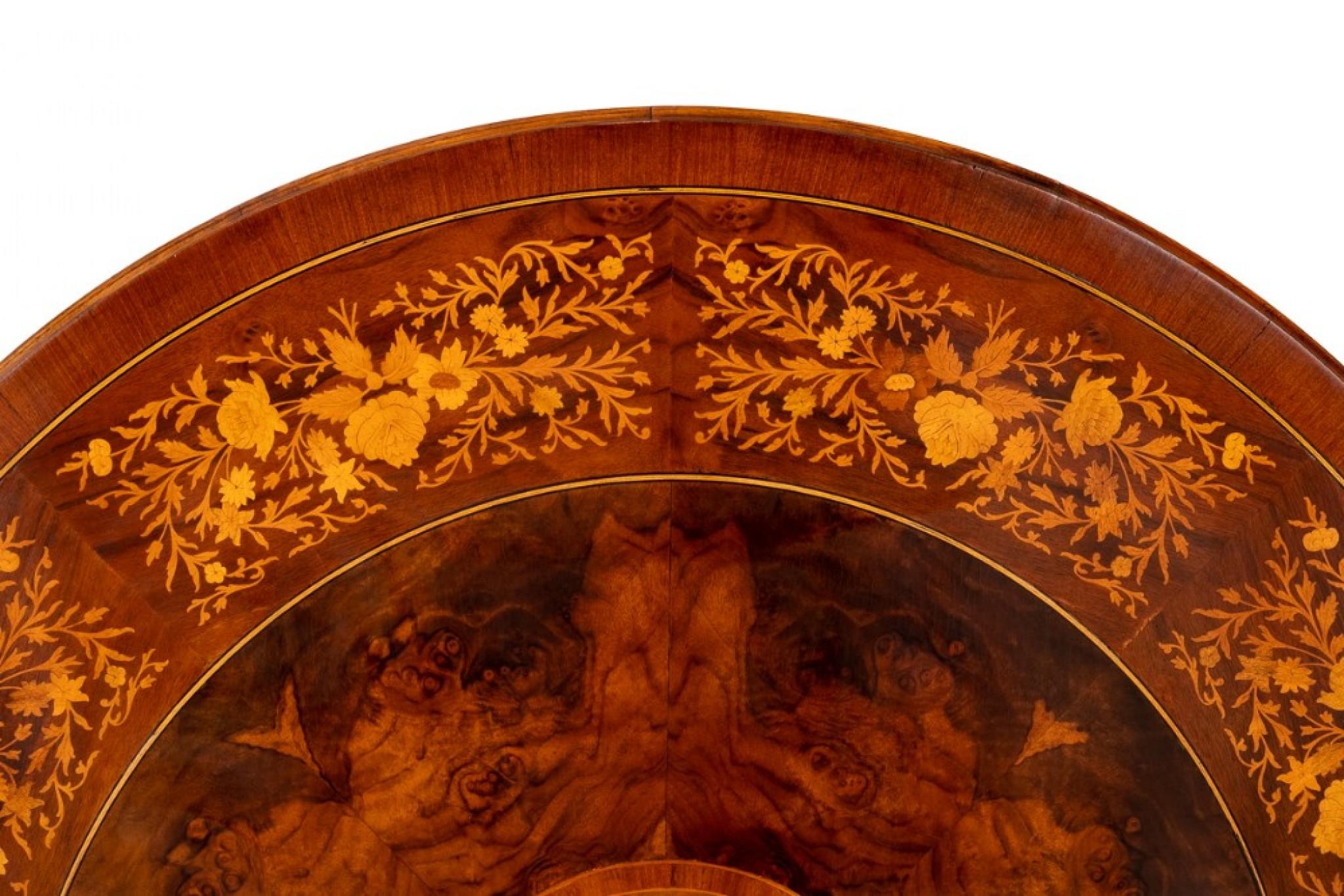 Victorian Style Walnut Marquetry Dining Table.
The Burr Walnut Top of The This Circular Table Features a Wide Band Of Floral Marquetry.
Circa 1900
The Table also Has a Central Disc of Floral Marquetry.
The Base of The Table having 3 Swept Legs With