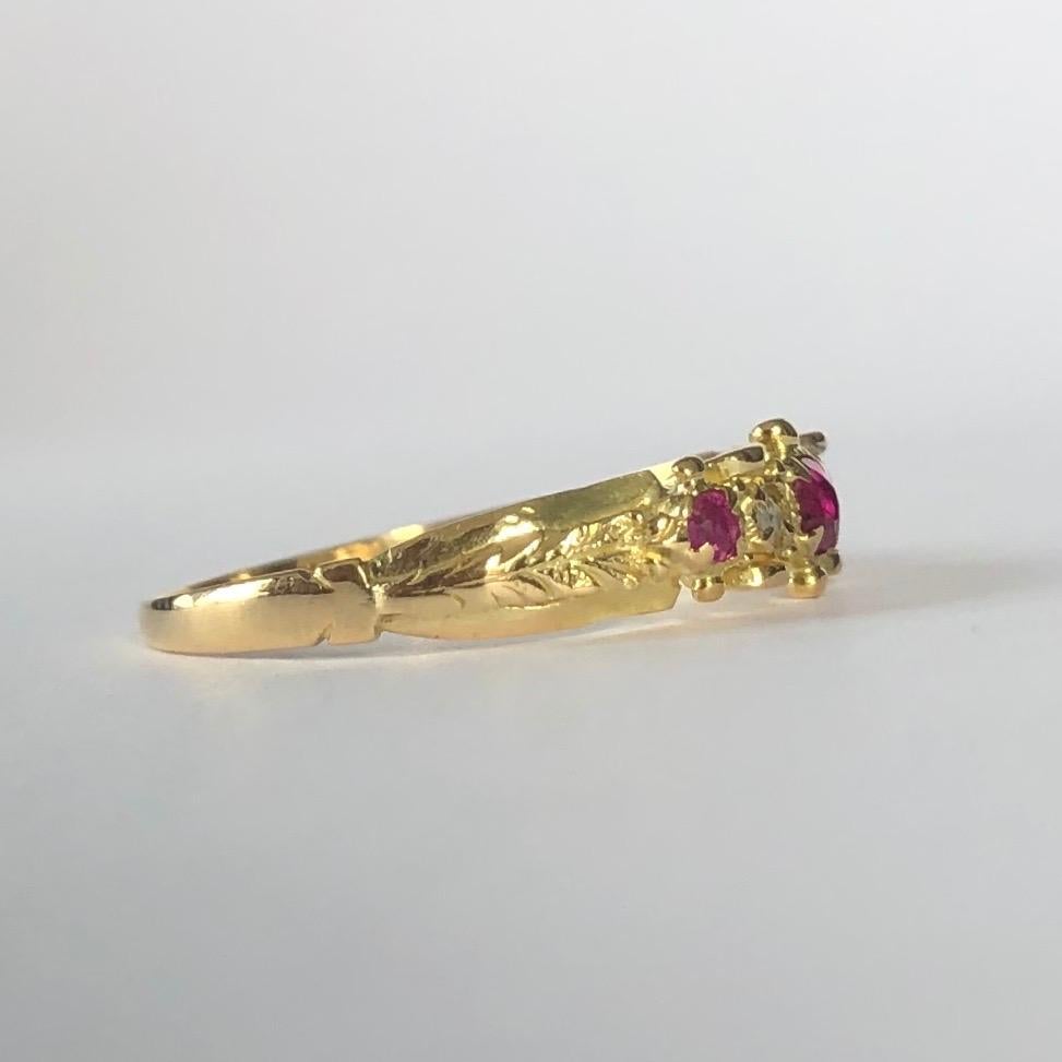 This simple and delicate band holds three rubies and two diamond points. The rubies total 15pts and are a gorgeous pink colour. 

Ring Size: J 1/2 or 5
Band Width: 4.5mm

Weight: 1.1g
