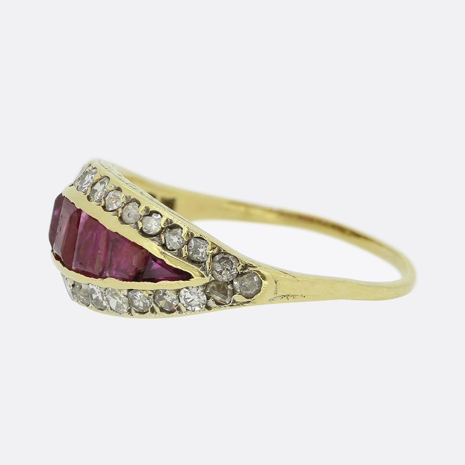 Here we have a delightful ruby and diamond ring from the Victorian era. This antique piece has been crafted from 15ct yellow gold and plays host to a graduating array of square calibrated rubies in a rub-over setting. These focal centralised stones