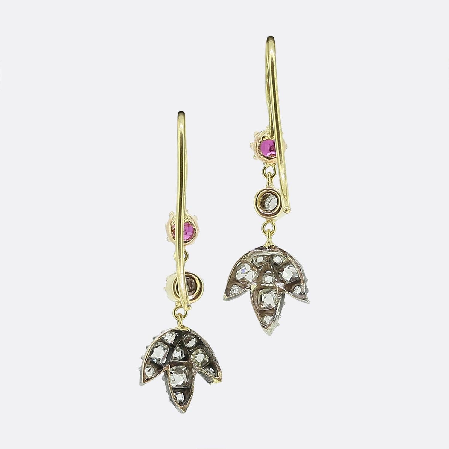 Here we have a recently remodelled pair of Victorian style drop earrings. Each piece has crafted from 18ct yellow gold with the hooked wire playing host to single pink ruby and a single old cut diamond. Both earrings are finished with a charming