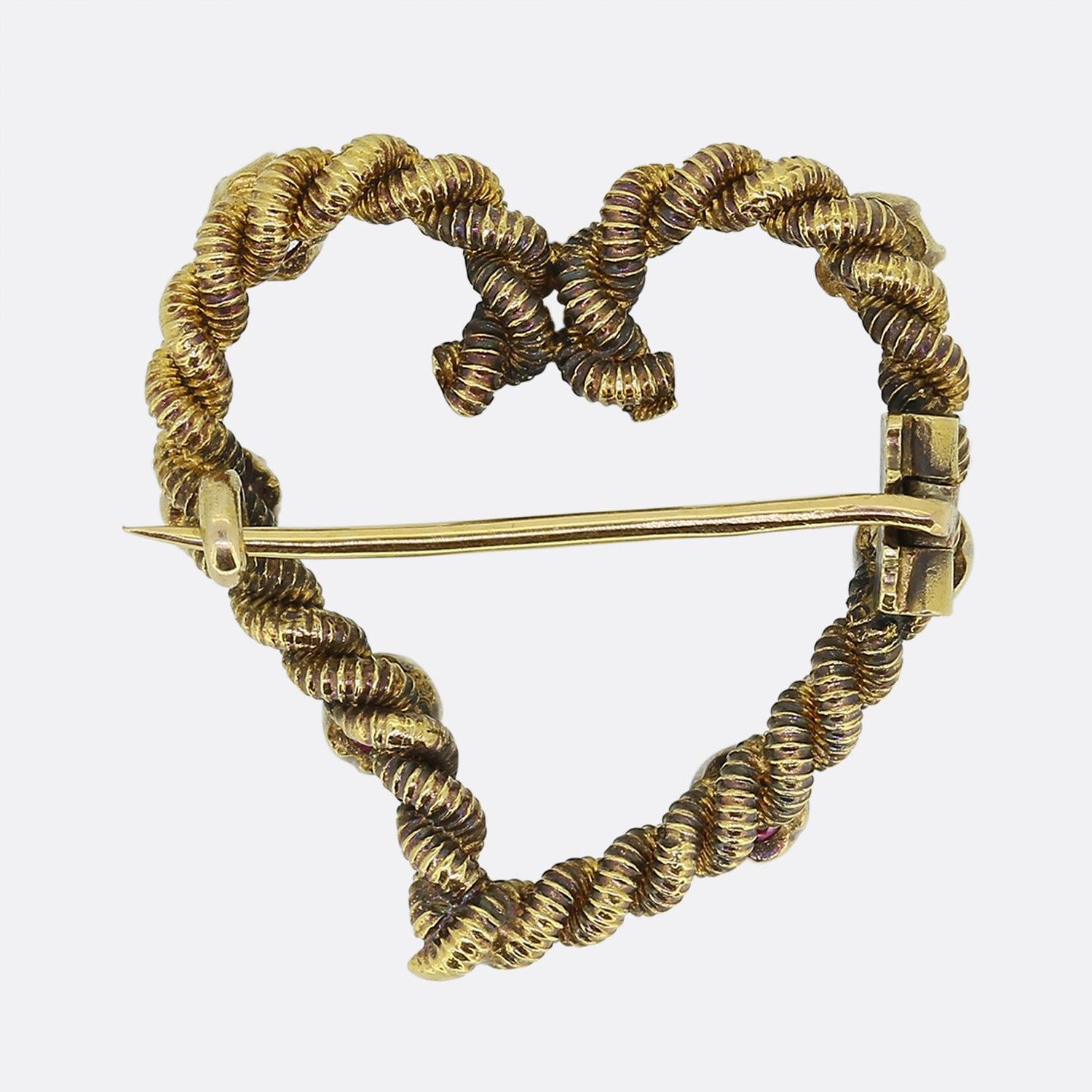 Here we have a delightful antique brooch dating back to the Victorian period. This romantic piece has been crafted from 22ct yellow gold into the shape an open love heart. This frame showcases a roped design and plays host to six claw set pinky