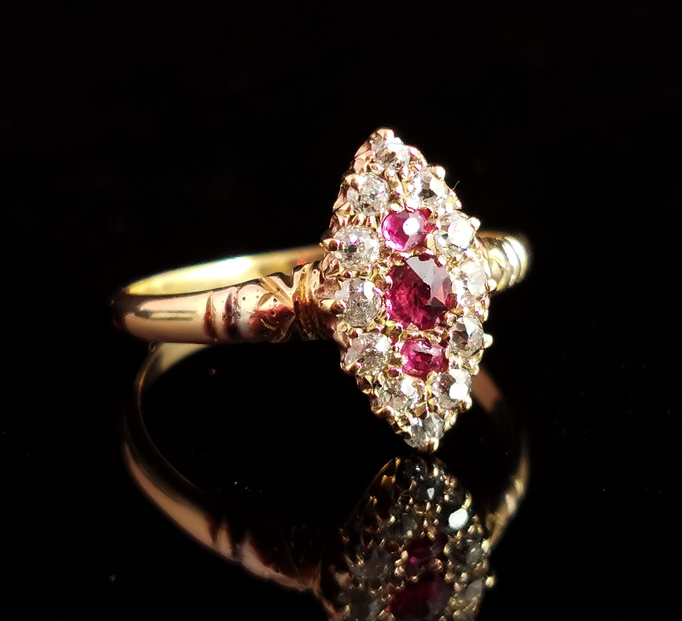 An impeccable antique, late Victorian era Ruby and Diamond navette ring.

This stunner features a central navette shaped panel with three pinky Rubies, the largest to the centre surrounded by a sparkling halo of twelve old cut diamonds.

The