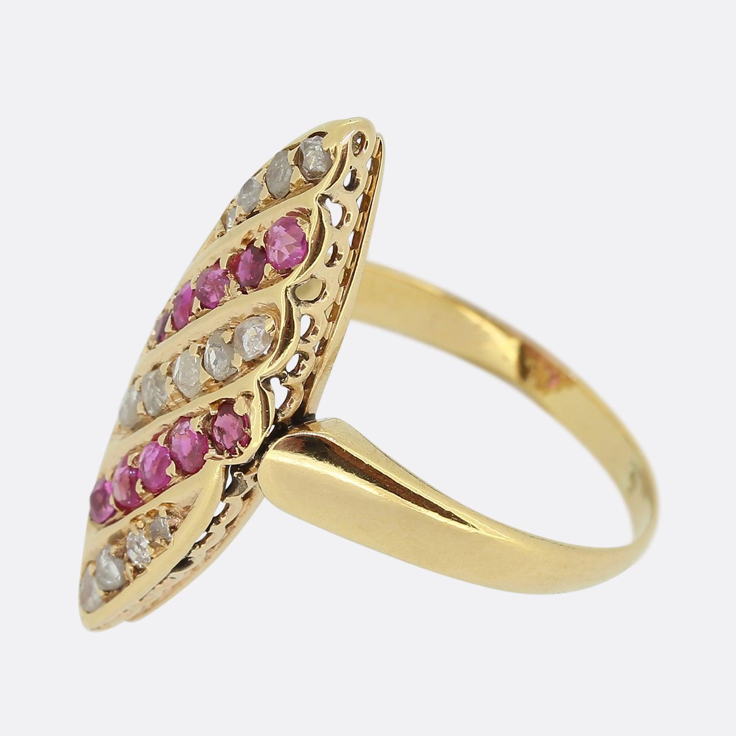 Here we have a gorgeous ruby and diamond navette ring from the Victorian era. This piece's boat-like shaped face has been crafted from 18ct yellow gold and plays to five alternating diagonal rows of rose cut diamond and round faceted rubies