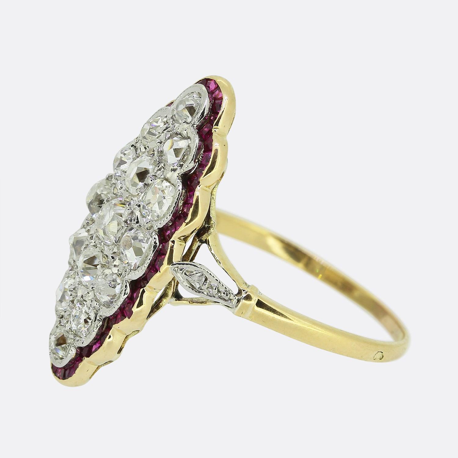 Here we have a truly beautiful ruby and diamond navette ring dating back to the Victorian period. A cluster consisting of fifteen round faceted old cut diamonds fill the centre of face and and are contained within a fine milgrain detailing. Intense