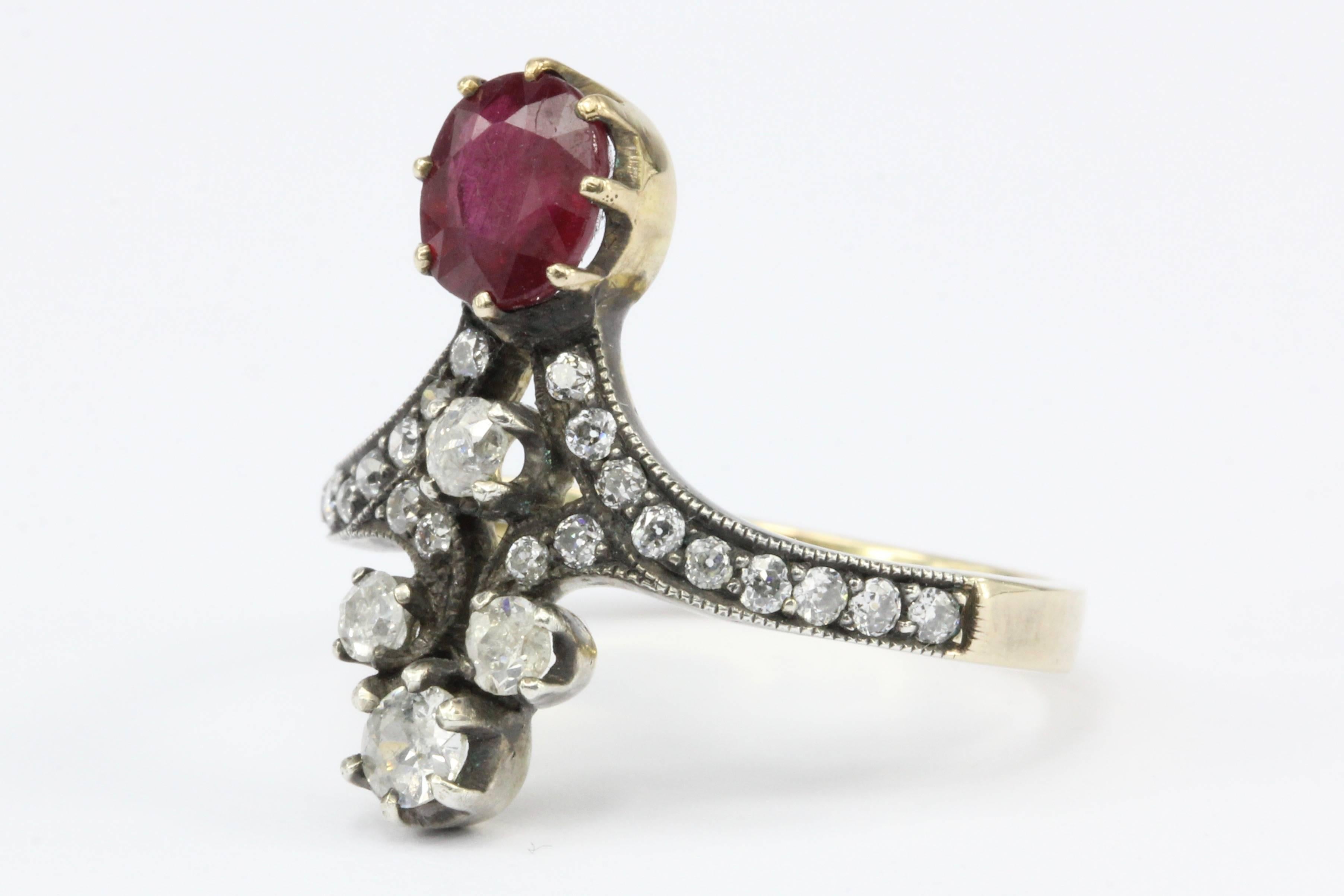 Era: Victorian  

Composition: 18K Yellow Gold & Silver Top

Primary Stone: Natural Ruby 

Primary Stone Carat Weight: Approximately 1 CT

Secondary Stone: (26x) Diamond 

Secondary Stone Cut: Old European Cut 

Secondary Stone Color: G-J

Secondary