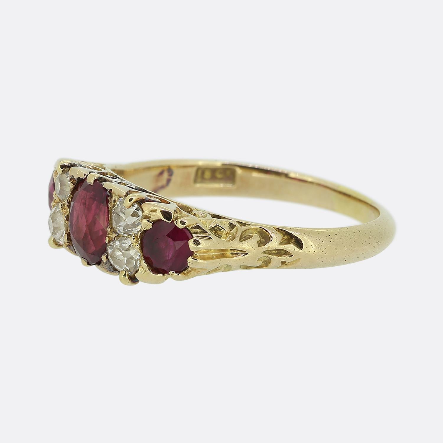 Here we have a classically styled three-stone ruby and diamond ring. This antique piece has been crafted from 18ct yellow gold and showcases a trio of rich red rubies; the largest of which sits at the centre. These focal stones are separated and