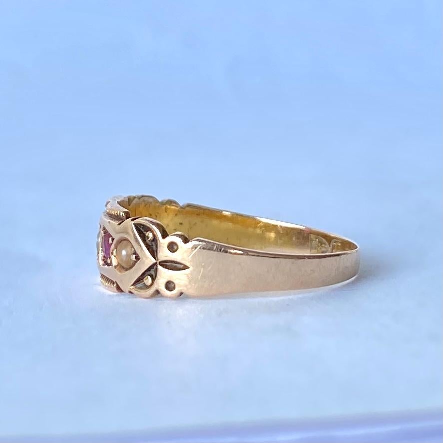There are five stones set within this ring. There are two rubies and three pearls. The ring is modelled in 15carat gold and has lots of textured detail. 

Ring Size: O 1/2 or 7 1/2 
Band Width: 6.5mm 

Weight: 2.2g