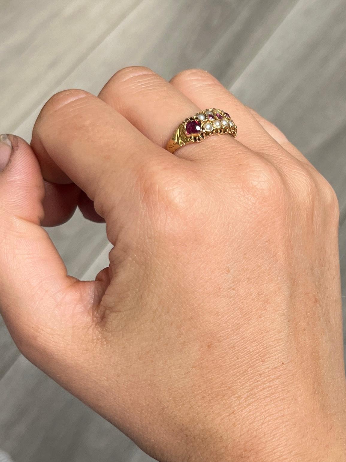 There are five rubies and eight pearls set within this ring.  The ring is modelled in 15carat gold and has lots of engraved and decorative detail. Hallmarked 1893 London England. 

Ring Size: P or 7 1/2 
Cluster Diameter: 7mm 

Weight: 2.2g