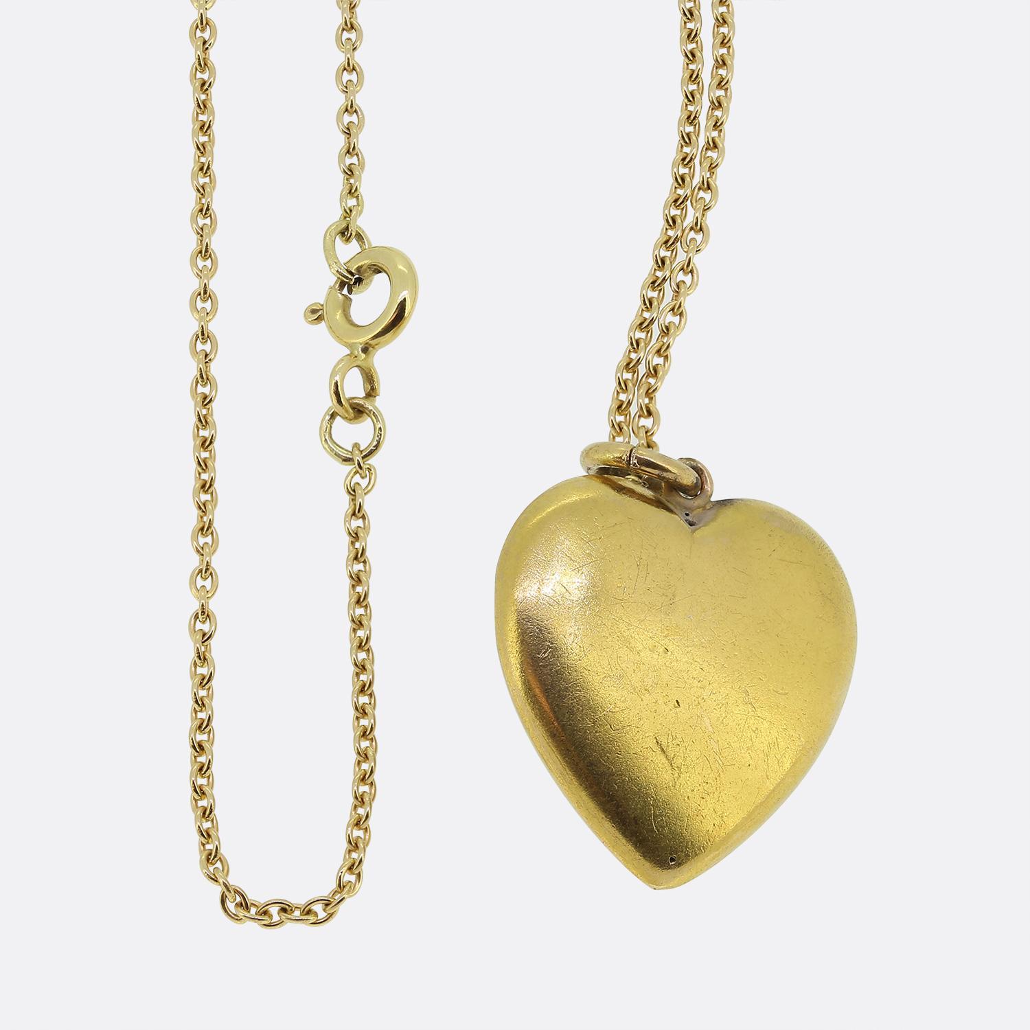 Here we have a delightful ruby and pearl set pendant necklace. This antique pendant has been crafted from 18ct yellow gold into the the shape of a love heart. The hollow body has then been expertly set with a duo of rubies and a pair of seed peals;