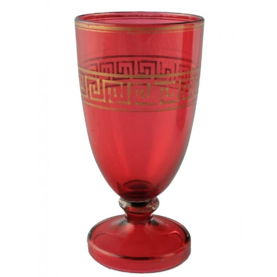 19th Century Victorian ruby glass jug and goblet.

The jug has a clear glass curved handle and a matching ruby glass goblet on a dome shaped foot. The jug and goblet both have a gilt greek key decoration around the centre and a gilt rim.

The