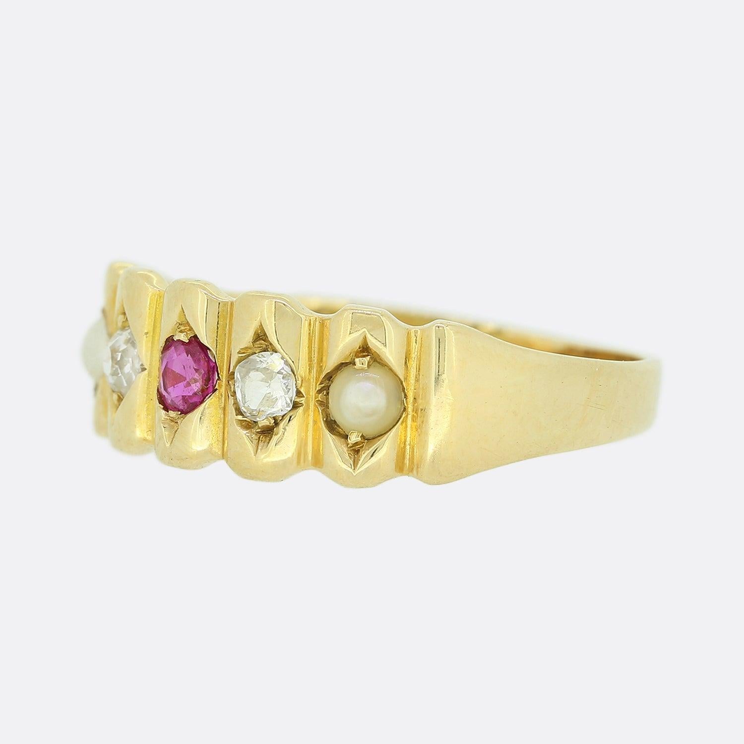This is an antique 18ct yellow gold ruby, pearl and diamond ring from the Victorian era. The ring features a neatly detailed  jagged face with an array of individually claw set gemstones in a line formation including a single Burmese ruby, a pair of