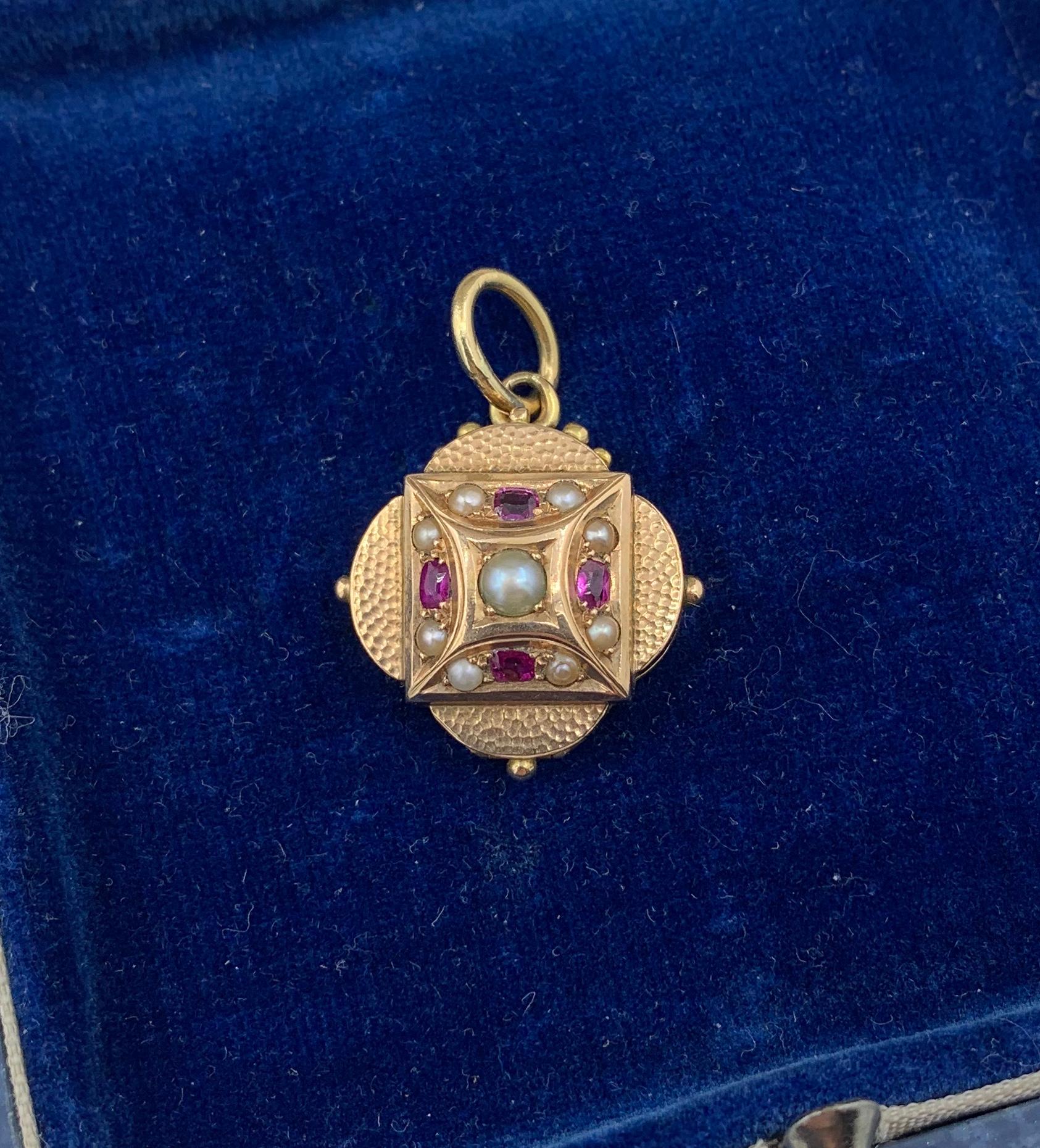 This is a rare and wonderful Victorian locket pendant with beautiful Ruby and Pearl adornments in 14 Karat Gold.  It is very rare to find antique jeweled Victorian Lockets.  This beauty is set with four beautiful oval faceted Rubies of a fine red