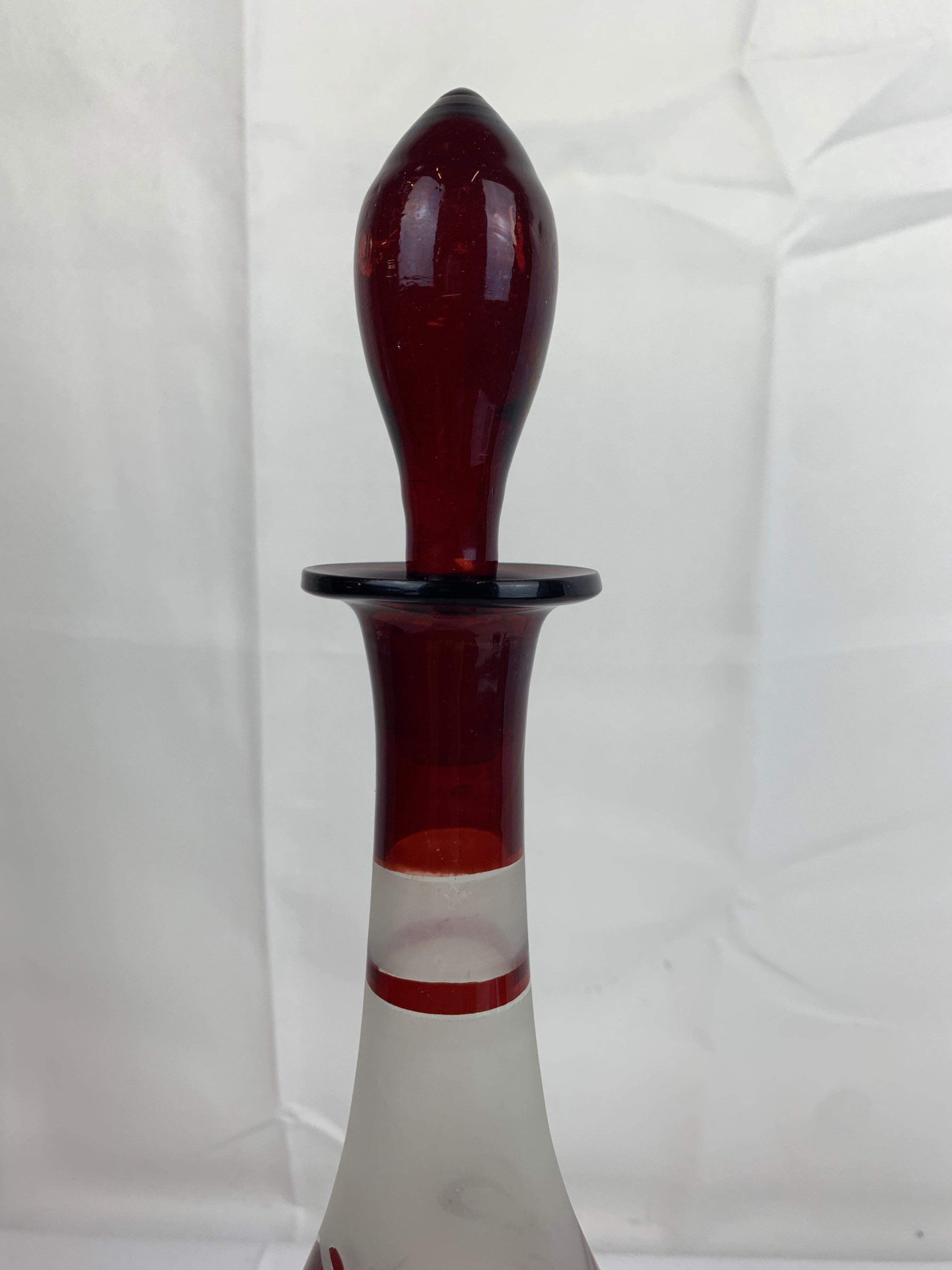 Ruby red wine decanter handsomely hand painted on a frosted clear glass. The decoration of swags tied with bows and morning doves is done with what is called 