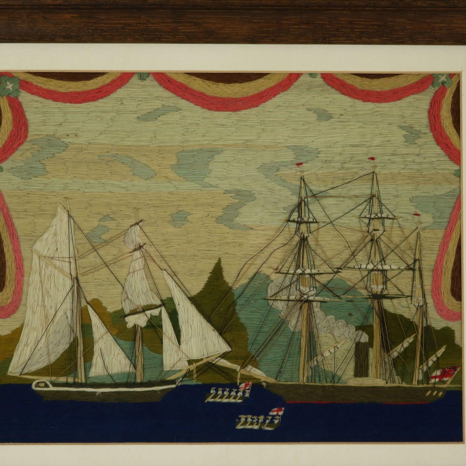 Antique Sailor's Woolwork Embroidery Picture of two sailing ships and sailors in rowing boats. One of the ships is steam powered, with smoke coming out of the chimney/smokestack. Drapes to the top and sides of the piece. The embroidery is worked in