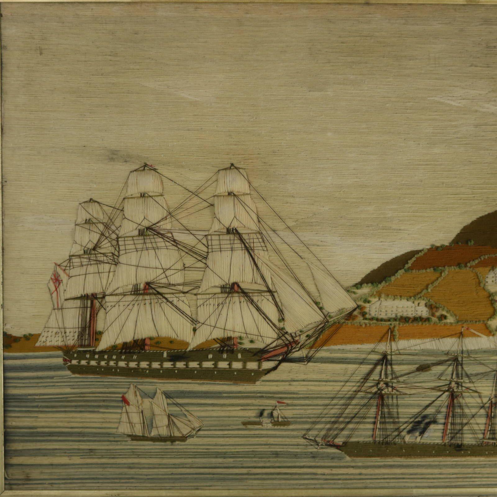 Antique Sailor's Woolwork Embroidery Picture of Ships in a Bay. The embroidery is worked in wool on linen ground, in a variety of stitches. Colours blue, brown, cream, green, black, grey, orange and red. Scene depicts a bay with a large three masted