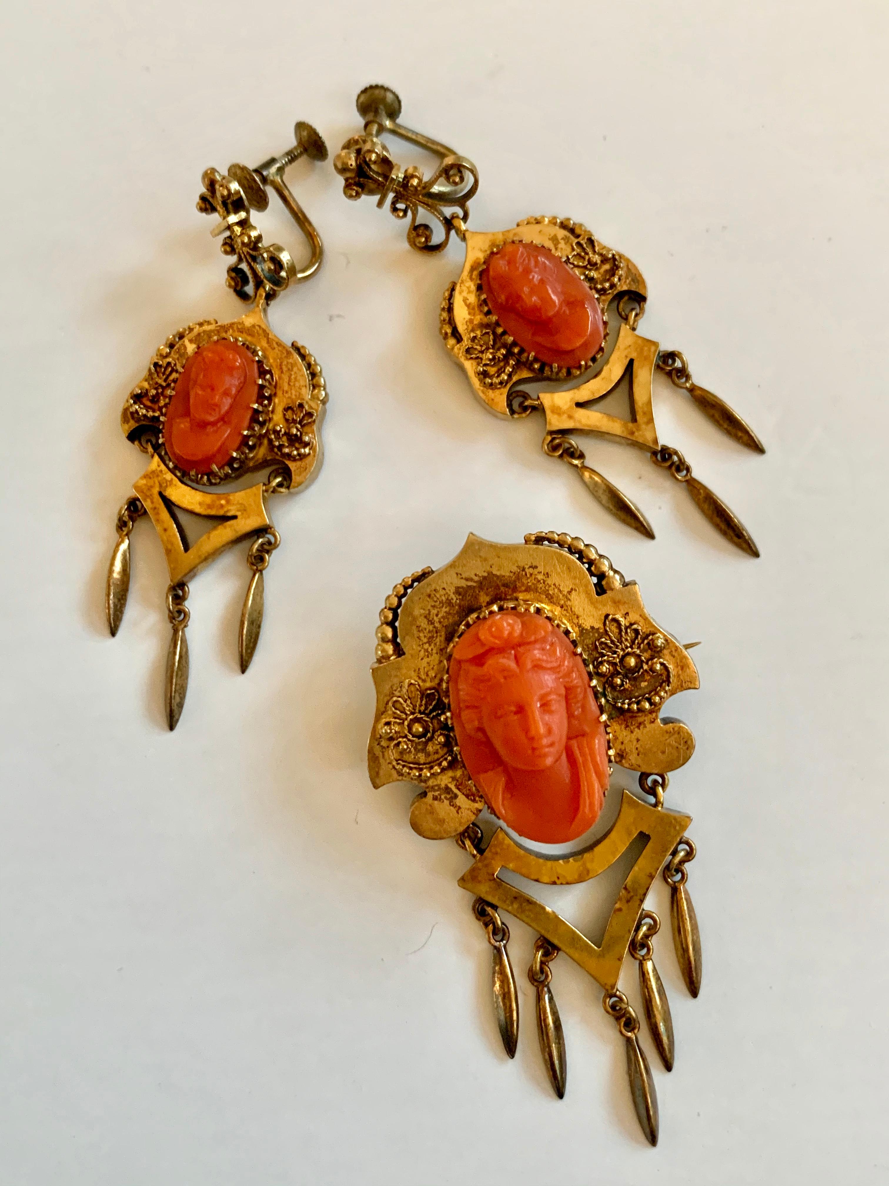 What a lovely Victorian 2 piece set.  This set includes a pair of screw back earrings and a brooch/pin.  Each piece features a very detailed carved Coral Cameo.  

Brooch Measurement: 1