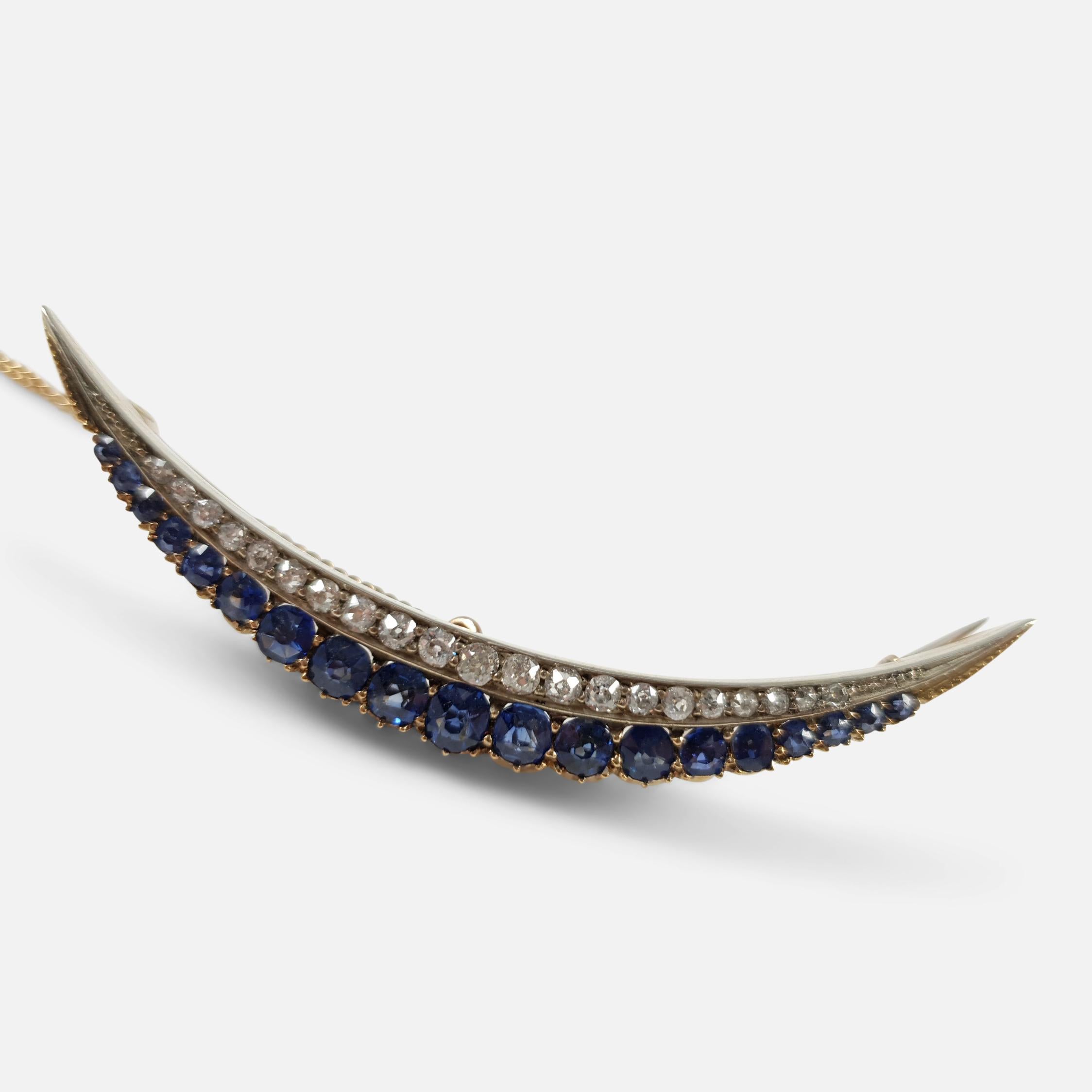 A late 19th-century Victorian brooch, crafted circa 1890s, featuring sapphires and diamonds set in a crescent design. The brooch combines silver fronting with a 9 carat gold backing, typical of the period but is unhallmarked; however, it has been