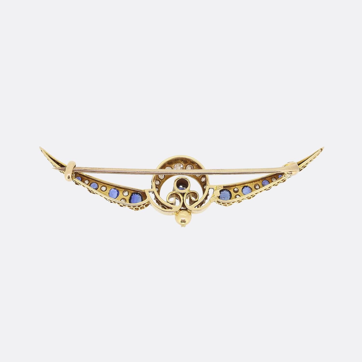 This is a gorgeous sapphire and diamond set crescent moon brooch dating back to the Victorian period. It is crafted in 18ct yellow gold featuring a single row of claw set old cut diamonds and natural blue sapphires which graduate in size towards the