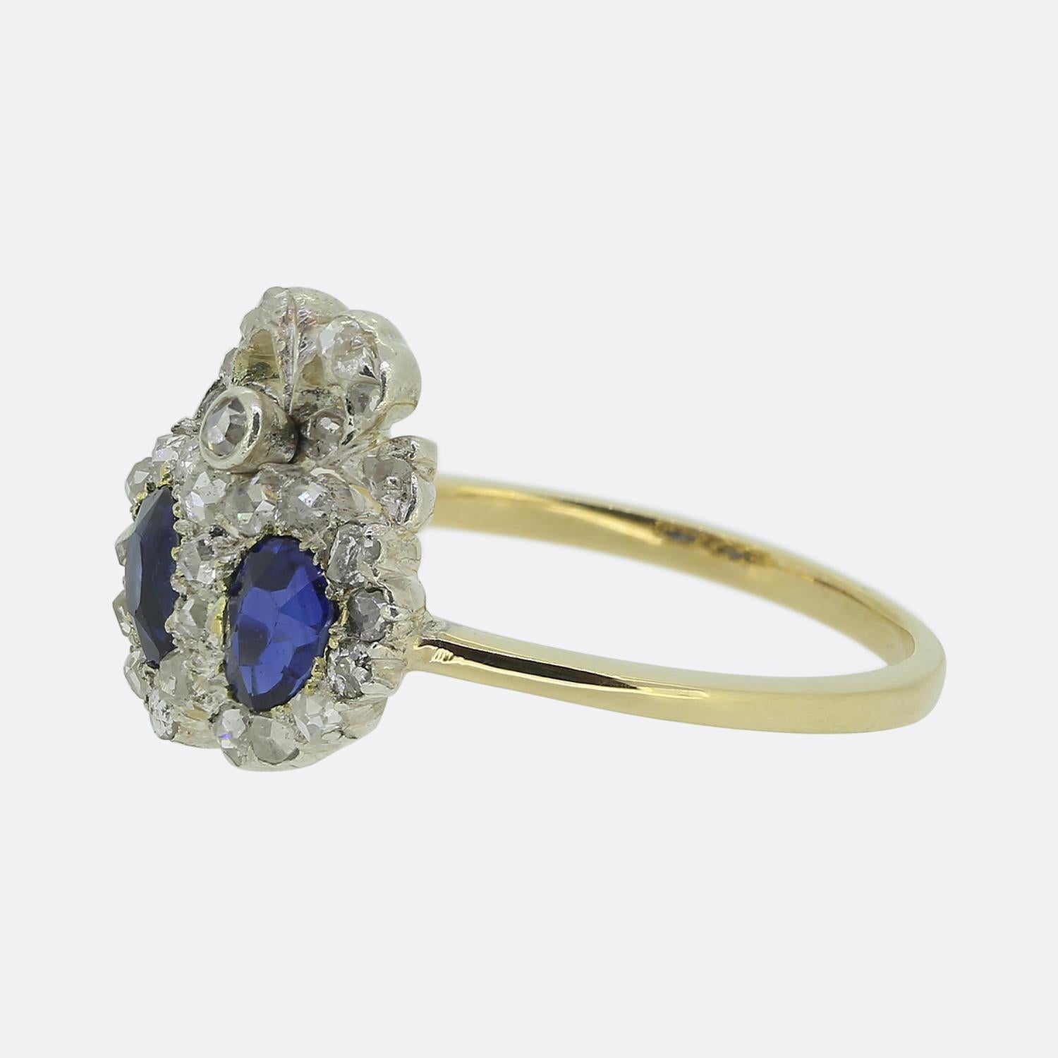 Here we have a fine example of a late Victorian double heart ring. In this case, a duo of pear cut sapphires possessing a vibrant navy blue colour tone sit at the centre of an accentuating boarder of shimmering rose cut diamonds. A matching diamond