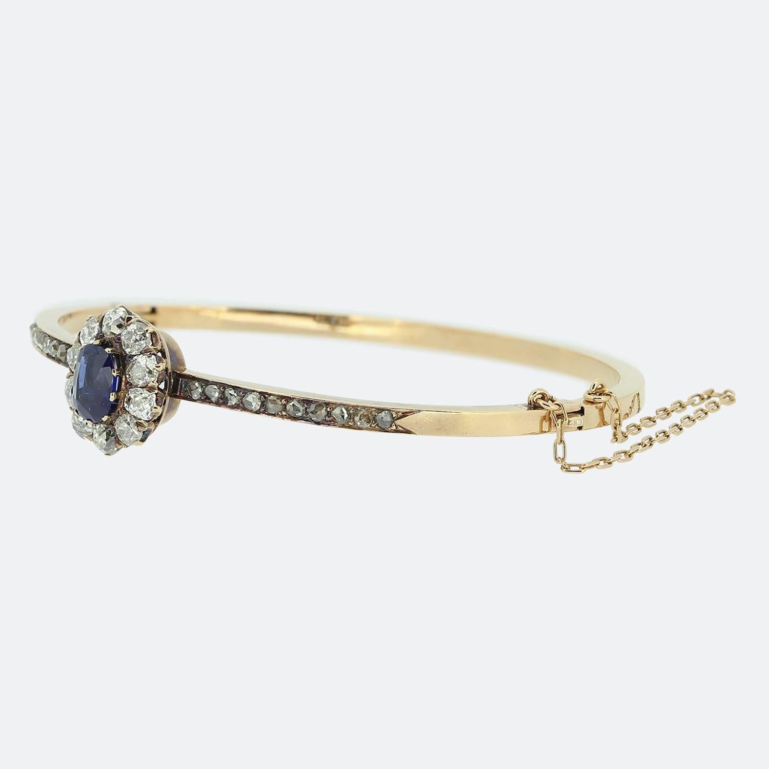 Here we have a marvellous sapphire and diamond bangle from the Victorian era. The focal point of the bangle is a stunning rich blue sapphire which is surrounded by 10 bright white old cut diamonds. The bangle is crafted in 15ct rose gold and each