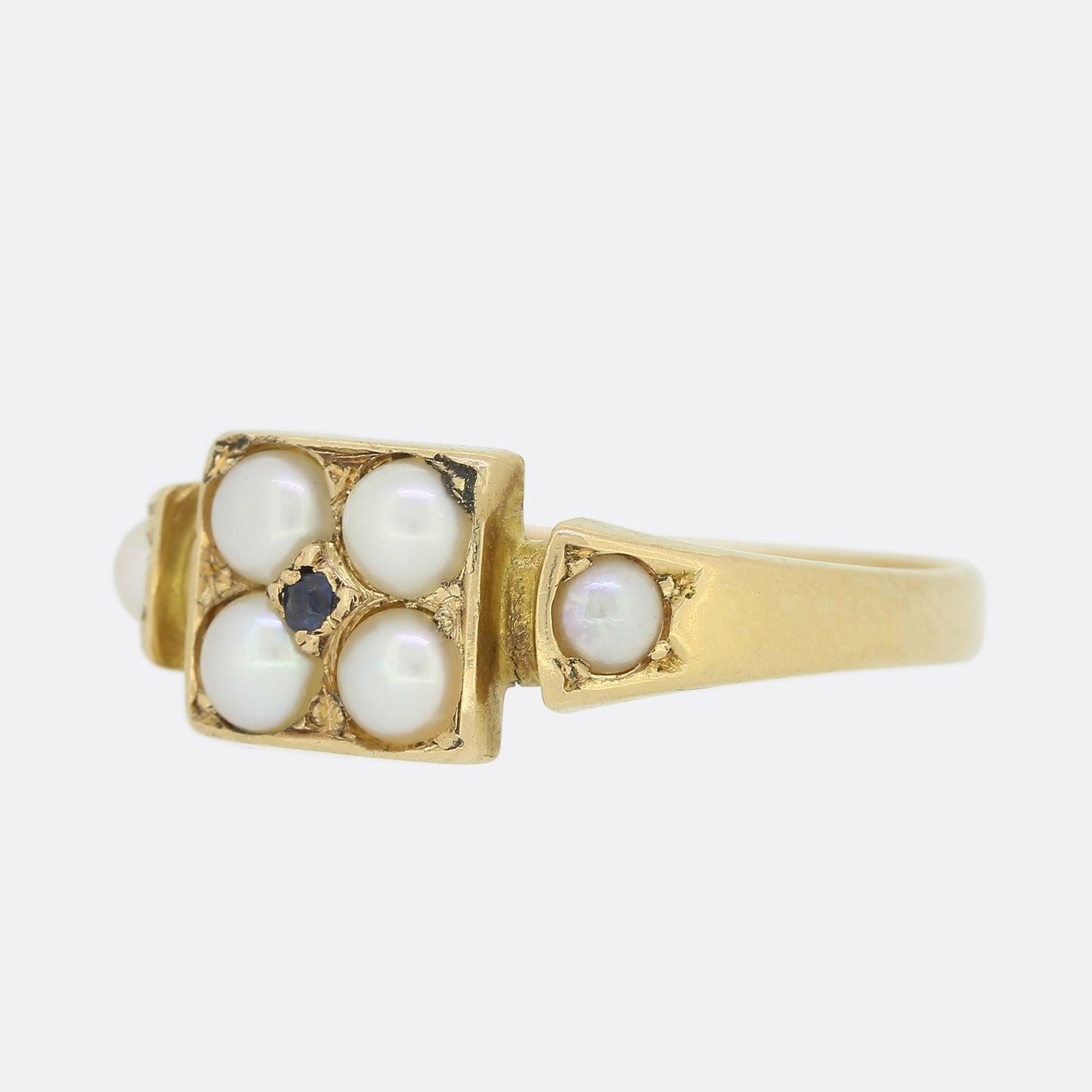 This is a wonderful 15ct yellow gold antique ring. Within a face crafted into the shape of a square sits four sizeable round pearls; one in each corner with a single deep toned sapphire being centrally claw set.  The piece is finished with shoulders