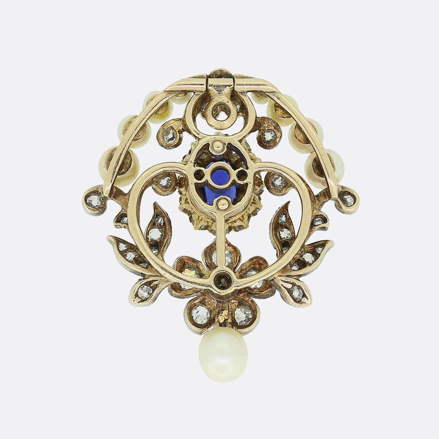 This is a truly magnificent antique piece from the Victorian era.  Firstly, an oval shaped sapphire possessing a highly desirable rich blue hue sits at the centre and is encompassed by a cluster of circulating old cut diamonds. This pendant's floral