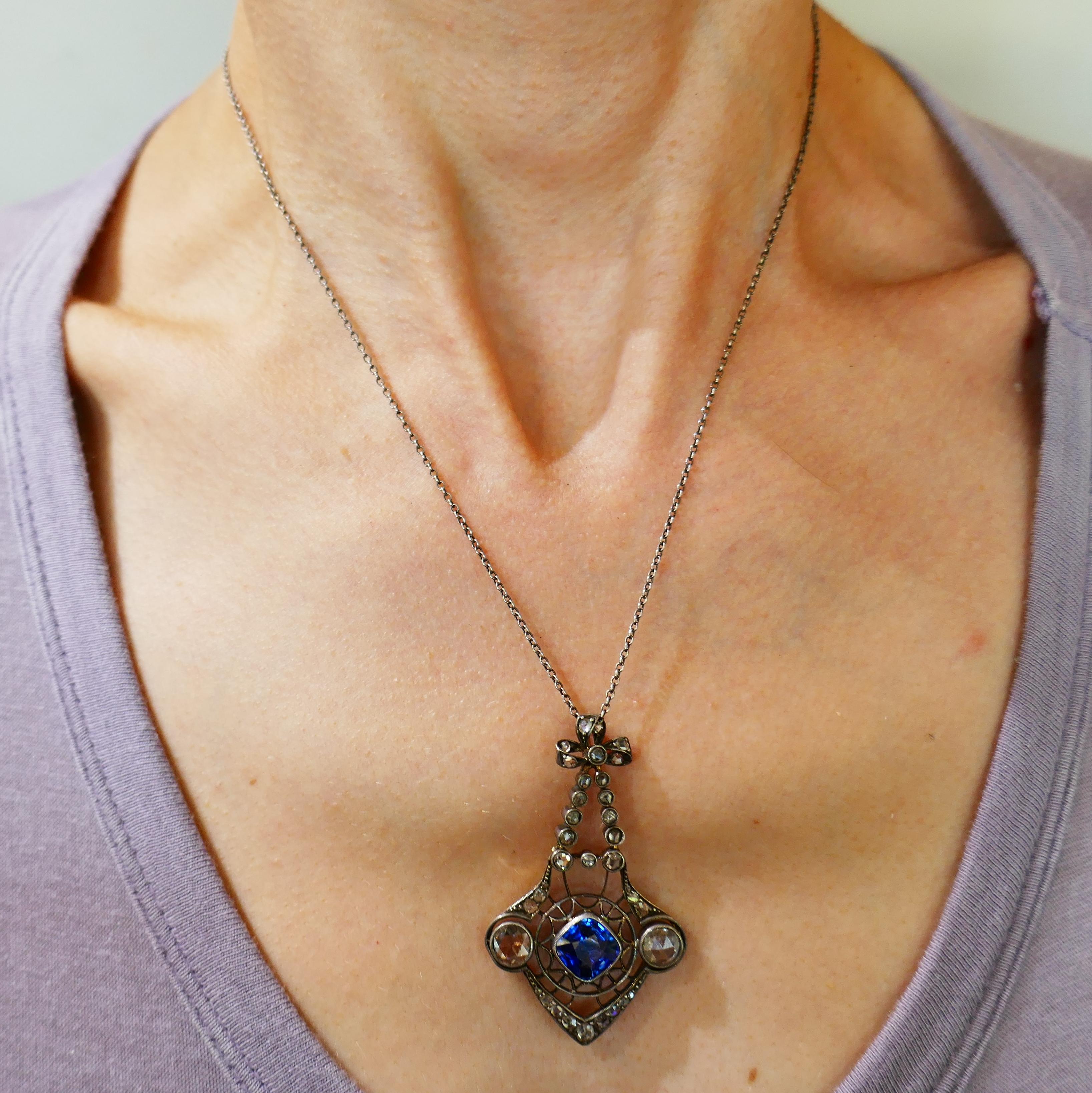 Beautiful Victorian pendant necklace. Trendy and wearable, the necklace is a great addition to your jewelry collection.
Made of silver and 14 karat (tested) yellow gold, the pendant features a cushion cut sapphire and rose cut diamonds. The sapphire