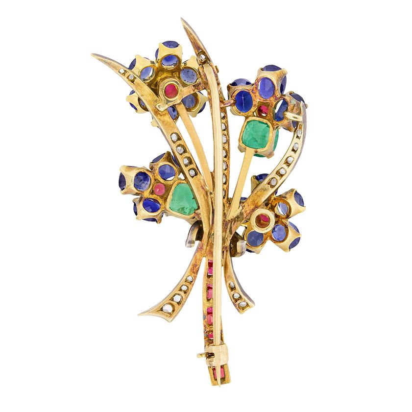 Dating to the 1880s, this brooch is beautifully handmade into the floral pattern. It is a mix of sapphires, diamonds, rubies and emerald, all claw set within the pattern. The sapphires, which are the main gemstones, have a combined weight of 4.10