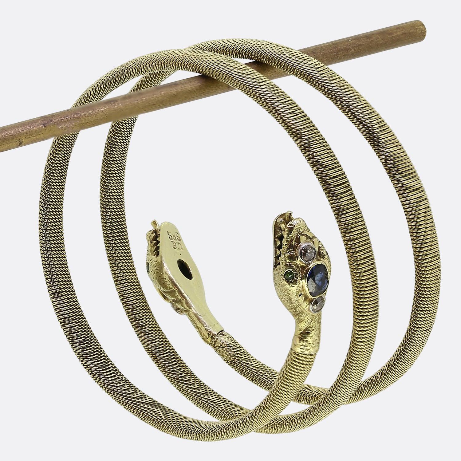 Here we have a wonderfully crafted gem set snake bracelet from the Victorian era. Crafted in 14ct yellow gold, this antique piece coils around the wearer’s wrist and features a flexible body with a secure steel spring inside. Between an intricately