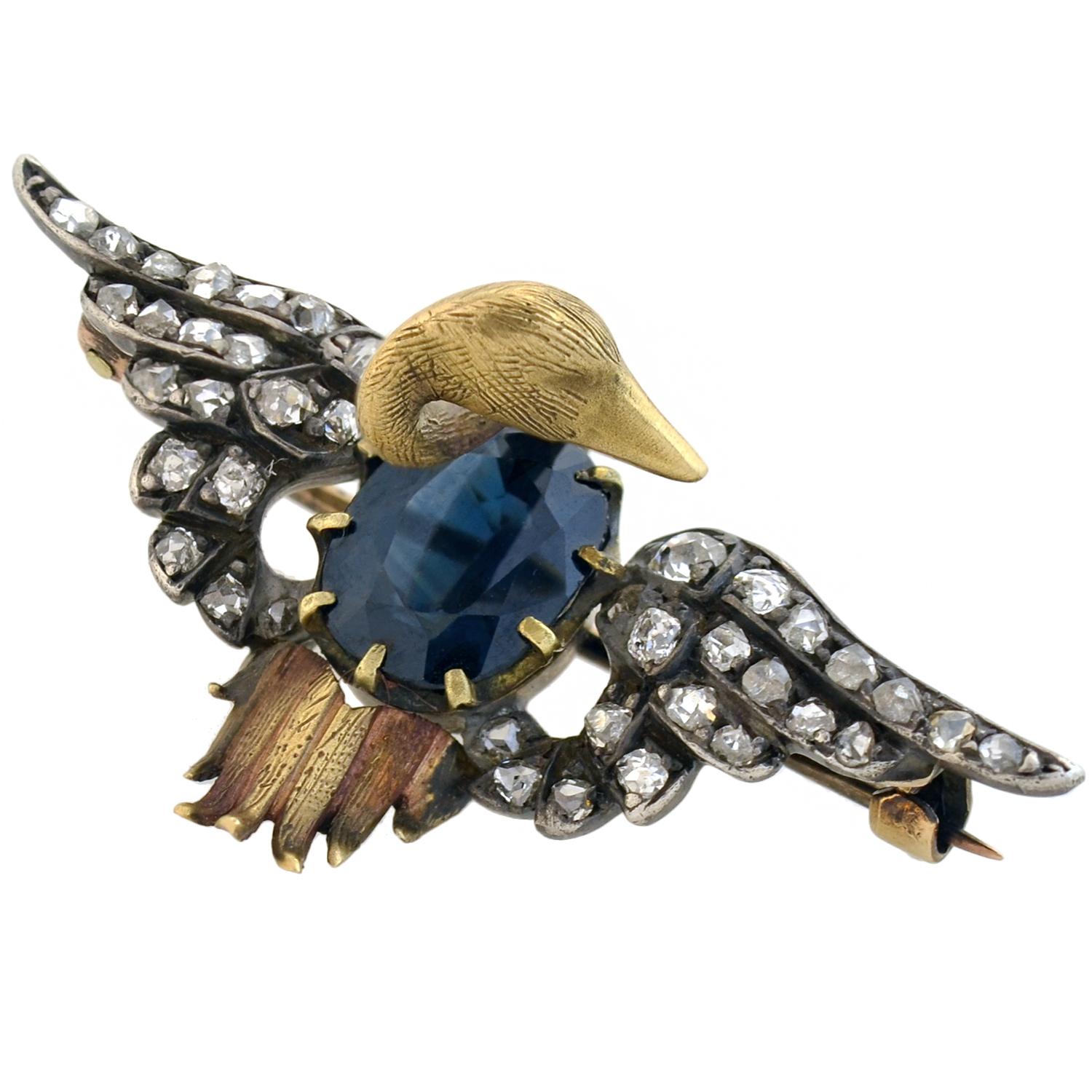 A magnificent sapphire and diamond swan pin from the Victorian (ca1880) era! Crafted in sterling silver topped 15kt yellow gold, this lovely piece features a three-dimensional swan with a beautiful and unusual design. At the center is the swan's