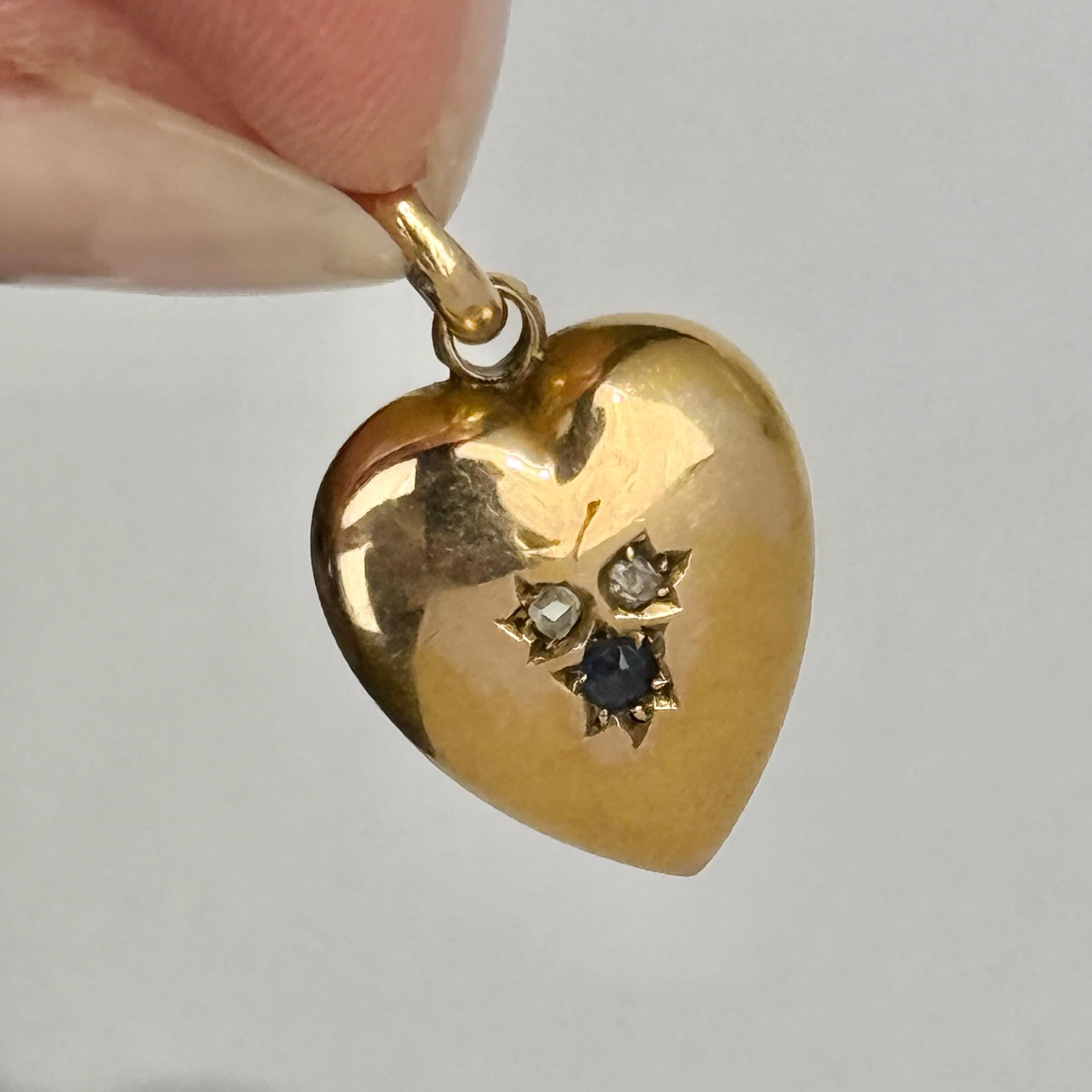 This pendant is modelled in 15 carat gold and has two rose cut diamonds and a sapphire set within it. Fully hallmarked 1897 Chester.

Dimensions: 16x14mm
Height including loop: 22mm

Weight: 1.8g