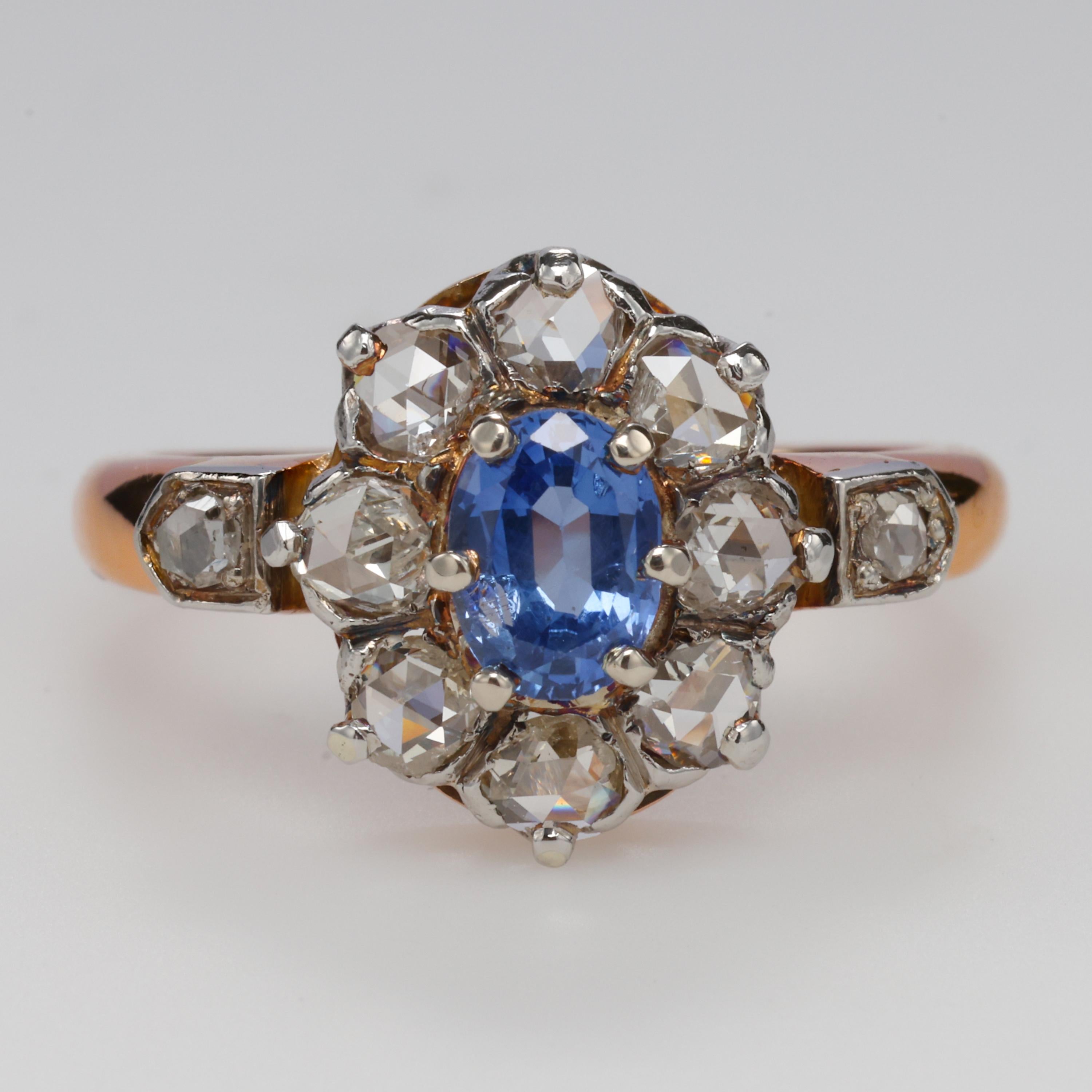 This gorgeous, Victorian-era (circa 1890) ring features an oval Ceylon sapphire that measures 6.07 x 4.4 x 2.70 and weighs half a carat. Eight .10 carat diamonds encircle it with two more on the shoulders. The diamonds weigh approximately one carat