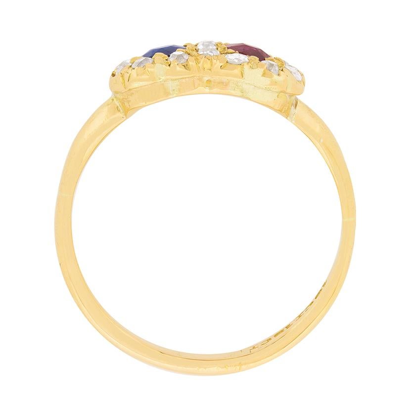 This ring features two stones, each weighing 0.30 carat, in the centre of a halo of diamonds. The blue stone is a natural sapphire, whilst the red, a natural ruby. They have been rub over set within 18 carat yellow gold and scalloped by old cut