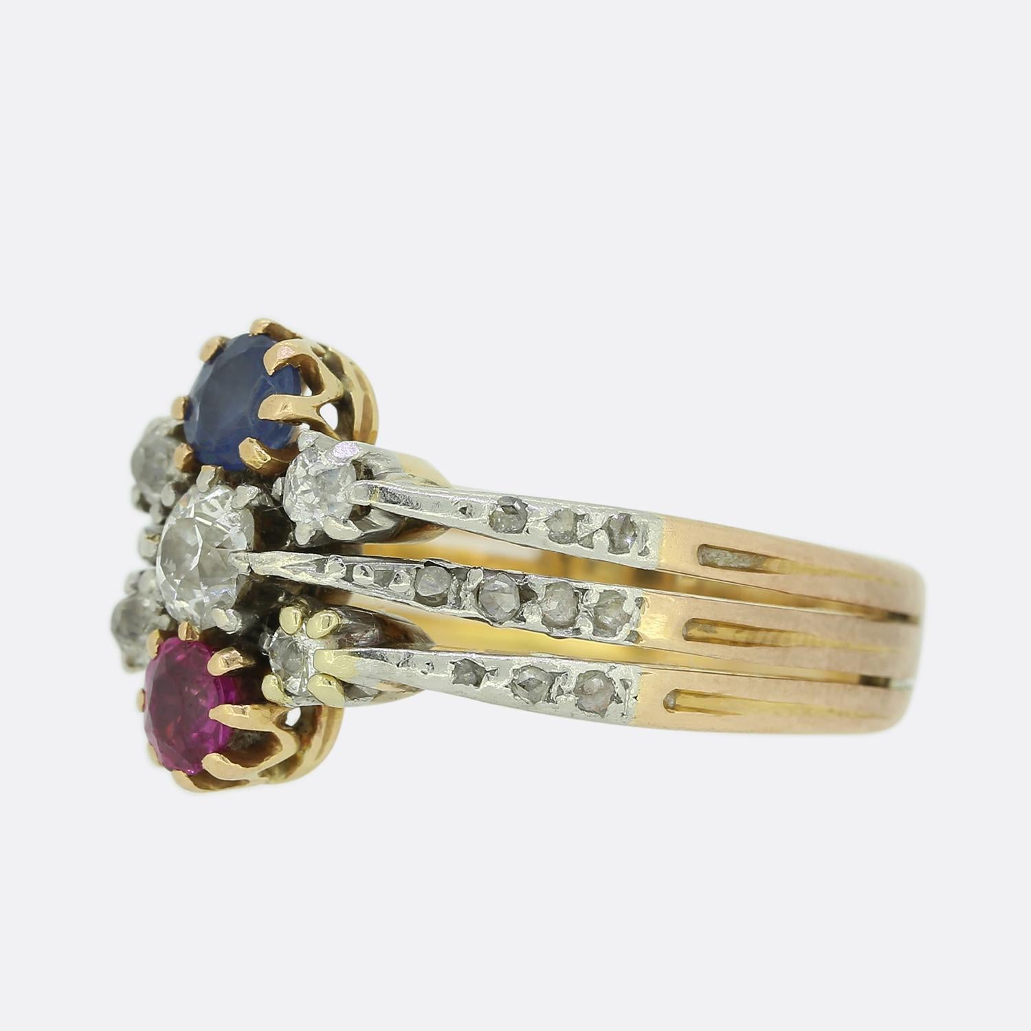 This is a fabulously colourful Victorian 15ct rose gold sapphire, ruby and diamond ring. Consisting of three connected bands, the first is centrally-set with a sapphire, the second with an old-cut diamond and the third with a ruby; collectively