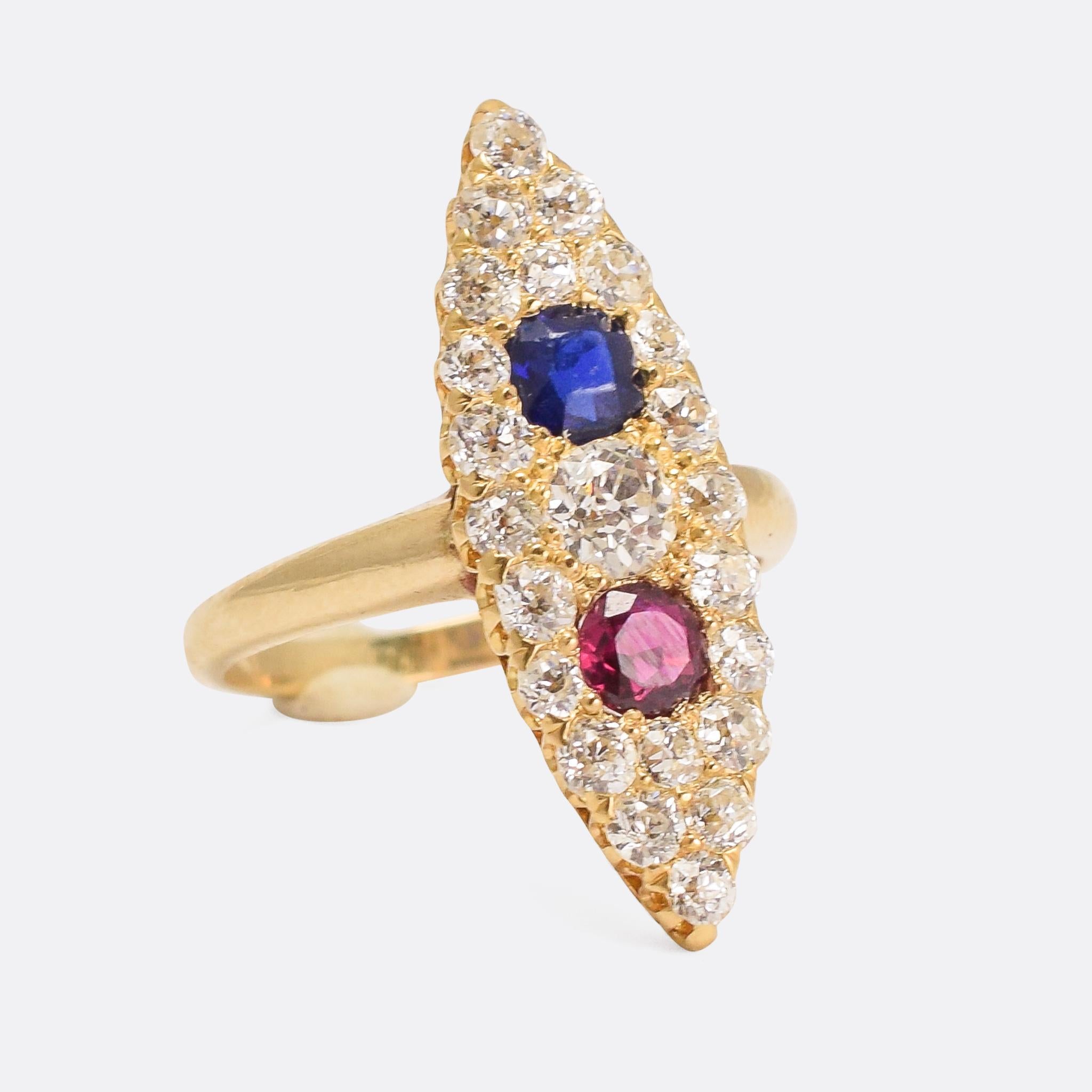 A spectacular Victorian Marquise Cluster Ring, pavé set with diamonds around a blue sapphire and a ruby. With an openworked claw gallery, and simple gold band, it's a gorgeously styled antique ring - very typically late Victorian. Modelled in 18k