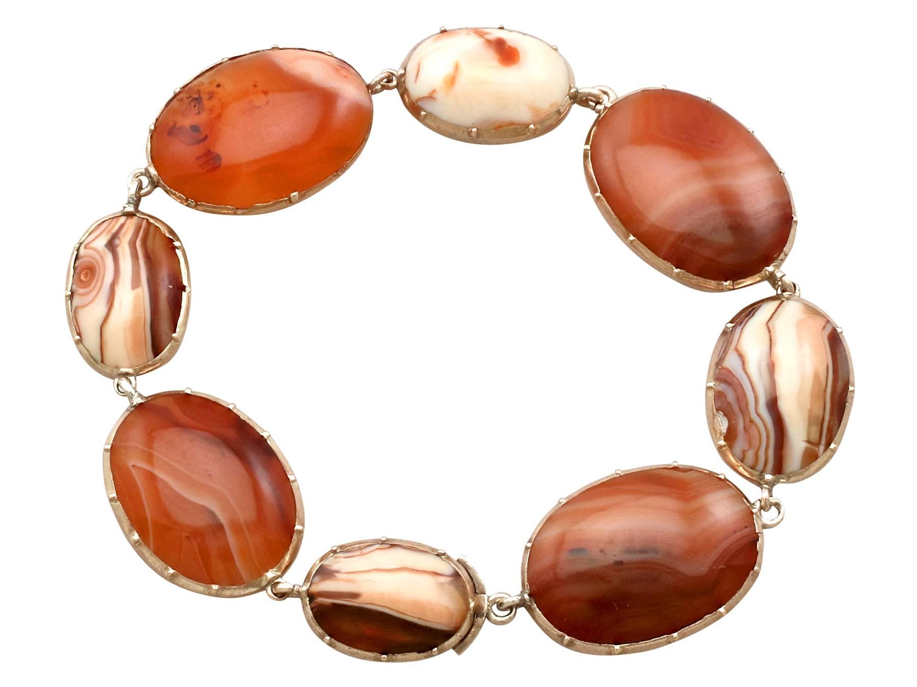 An impressive antique 1850s Victorian sardonyx and 9 karat yellow gold bracelet; part of our diverse antique jewelry and estate jewelry collections.

This fine and impressive antique cabochon cut agate bracelet has been crafted in 9k yellow