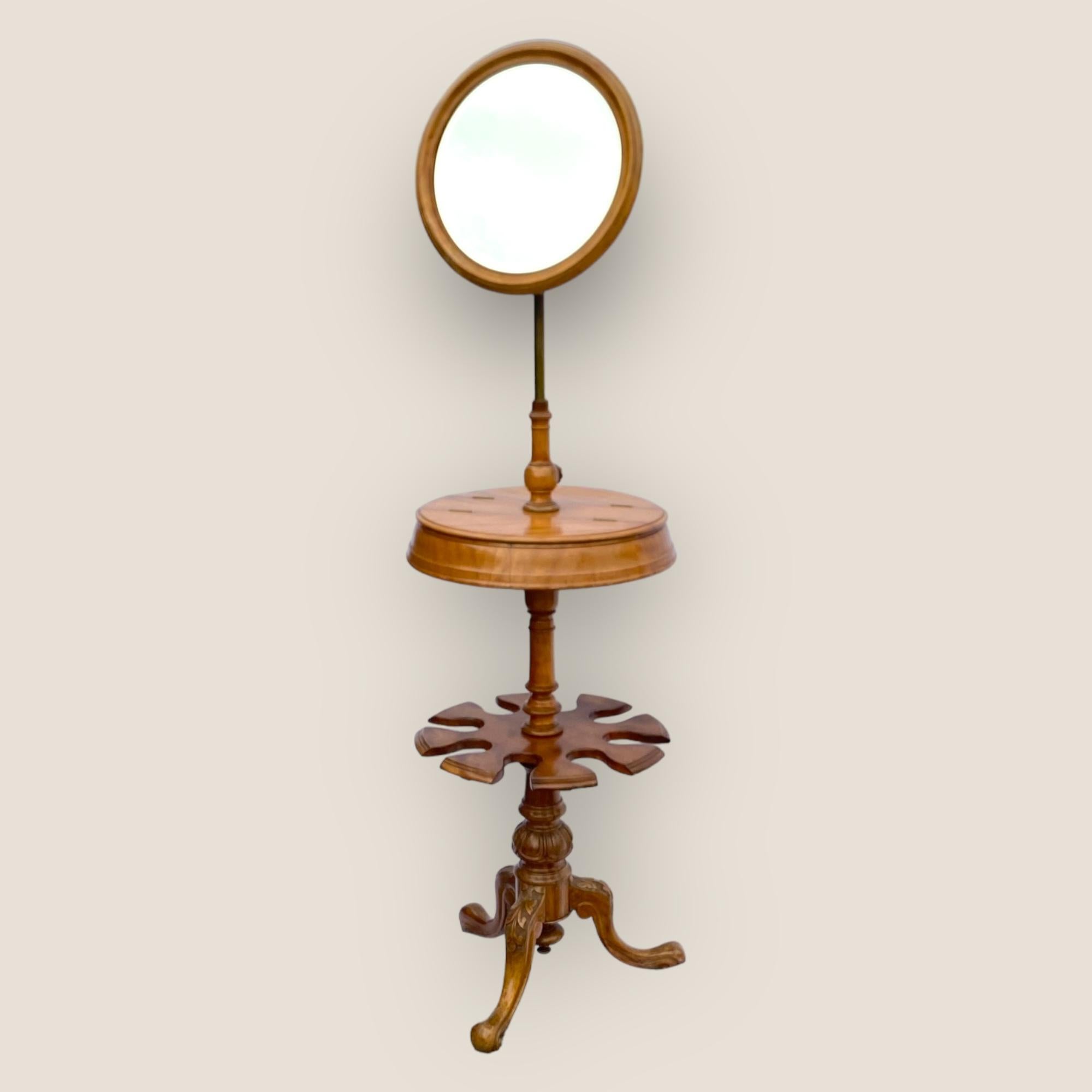 A Victorian Satin Birch Gentlemen’s Shaving Stand With a Mirror. A unique piece featuring adjustable mirror height and angle, a rotating two doored cupboard and further rotating section underneath, standing on carved tripod legs.
